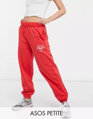 ASOS DESIGN Petite roll-waist oversized sweatpants with tennis logo in red | ASOS (Global)