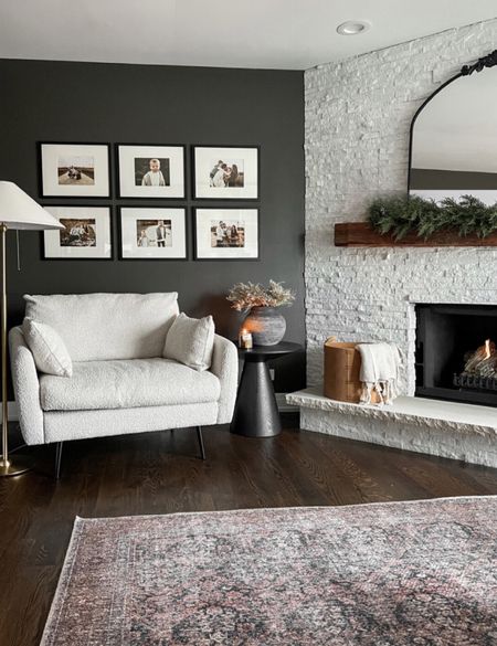 Simple moody holiday styling for this cozy corner 🤗 I love the dark wall in here against the boucle chair and fireplace! 

#LTKhome #LTKsalealert #LTKHoliday
