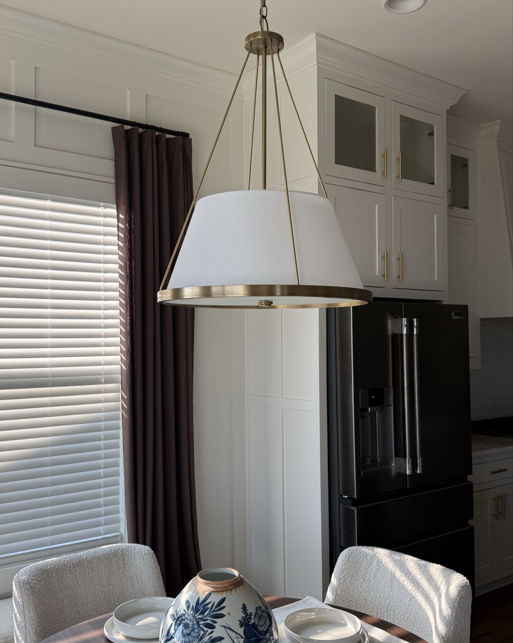 #ad The chandelier that made our dining room feel designed ✨

We moved in and immediately knew the builder-grade light had to go, and this was the upgrade! The warm brass finish + white drum shade gives such a classic, elevated look. @urbanambiancesocial 