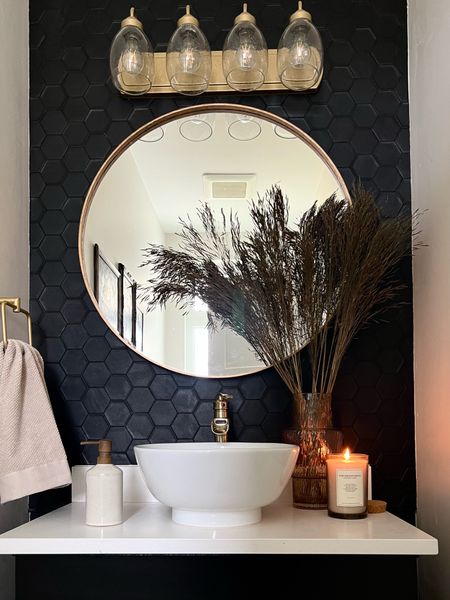 Moody powder room! I painted my ceramic tile black with Fusion mineral paint. It worked so well, and has held up great! 

#LTKFind #LTKhome