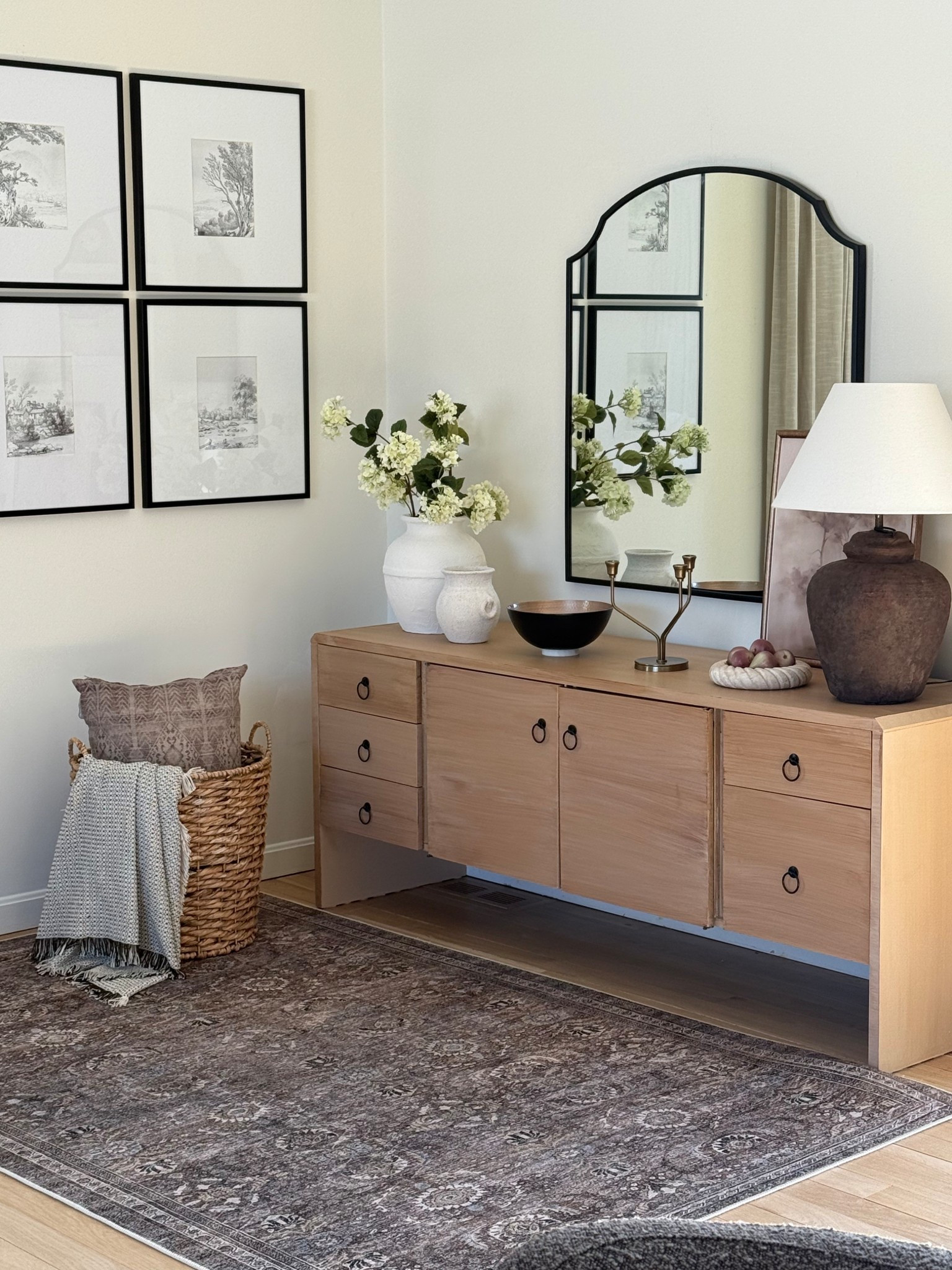 Adding some texture with blankets and a basket to fill in the corner of our family room. Thinking of adding some sconces next to this beautiful mirror!

#LTKHome