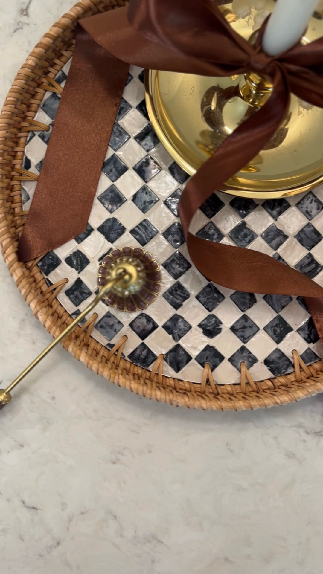 This styling moment features a
vintage-style candle snuffer paired with soft candlelight for a clean and intentional way to end your candle rituals.

Perfect for cozy home decor, coffee table styling, bedroom ambiance, and minimalist home aesthetics. A simple upgrade that makes candle lighting feel more refined and less messy. 

Linking the rattan tray with mother-of-pearl overlay, oversized brass chamberstick, vintage-style candle snuffer, and my favorite satin brown ribbon  

#LTKSaleAlert #LTKHome #LTKMothersDay