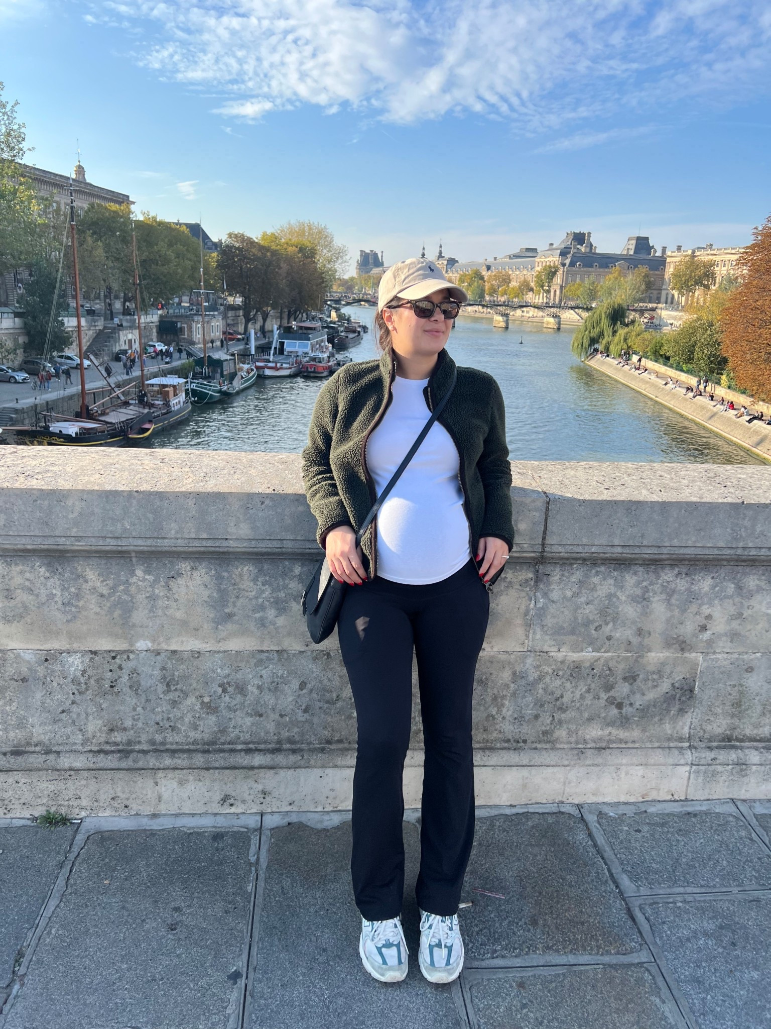 Casual travel outfit perfect for cold weather and bump friendly. Hat, sunglasses, flared pants, long sleeve top, jacket, crossbody bag, sneakers.

#LTKBump #LTKStyleTip #LTKTravel