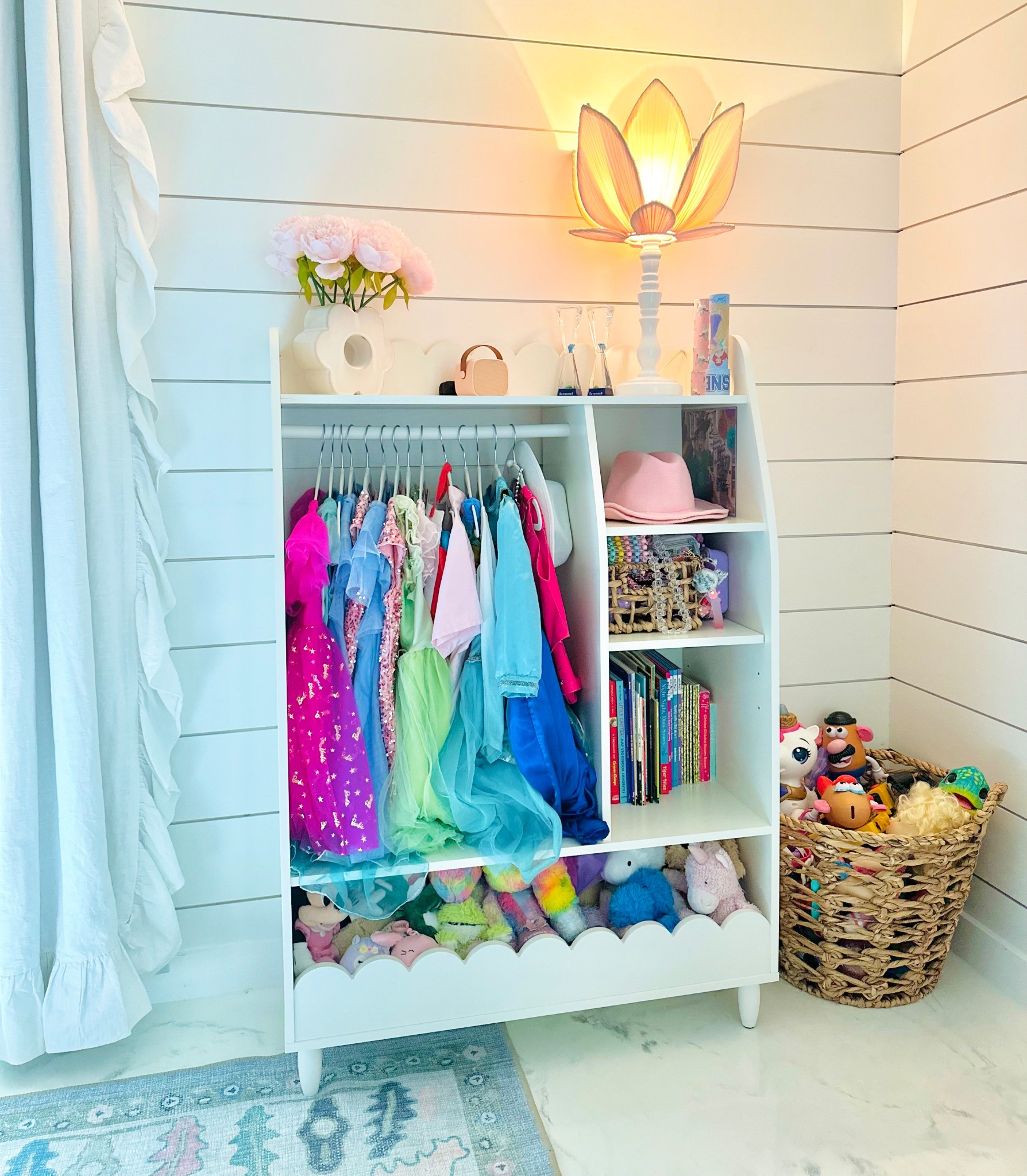 We recently updated the girls dress-up corner to the cutest scallop organizer and this one has shelves! The storage underneath and on top is so awesome we were able to put so much of the girls toys on this shelf!! #Wayfair currently has this #onsale and if you love all things scallop like I do, it’s totally worth it!! #wayfair #shopthelook #homedecor #kidsroom #biggirlroom #girlsroom #dressuporganizer #toyshelves #scalloporganizer 

#LTKHome #LTKKids #LTKSaleAlert