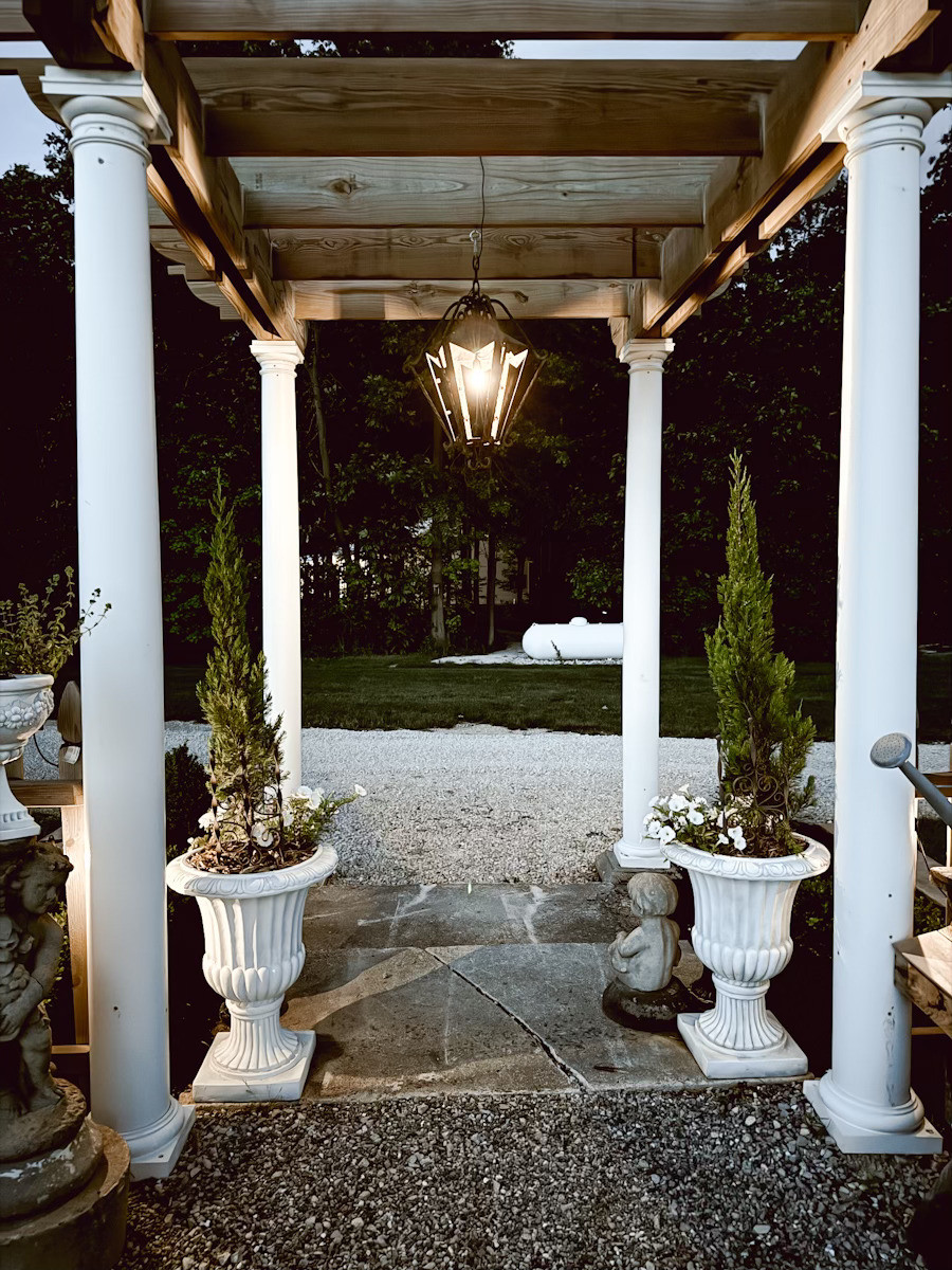 This is the entrance we created to our garden area. We layered in different layered planters next to these large pillars. We use solar lighting to light this area for an enchanting evening glow.  

 #LTKSeasonal #LTKHome