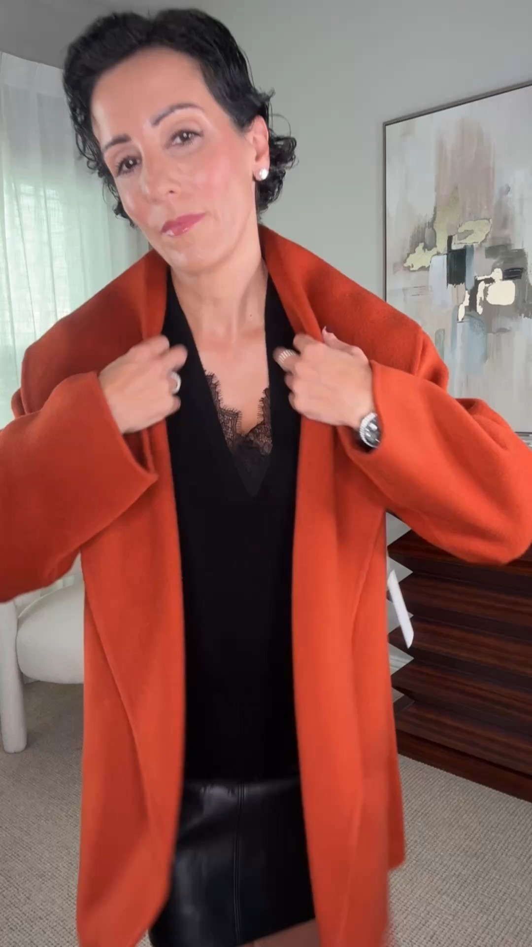 This rust-colored coat is such a beautiful statement for fall. I love the oversized lapels and relaxed silhouette, especially paired with a black lace-trim sweater and leather mini skirt. The warm color makes the entire outfit feel seasonal, while the black underneath keeps it sophisticated. A great coat that can dress up denim just as easily.

rust coat, orange fall coat, statement coat, fall outerwear, black lace sweater, leather mini skirt, fall outfit ideas, women over 50 style, elegant fall outfit, fall layering, classic wardrobe, stylewitheugenia