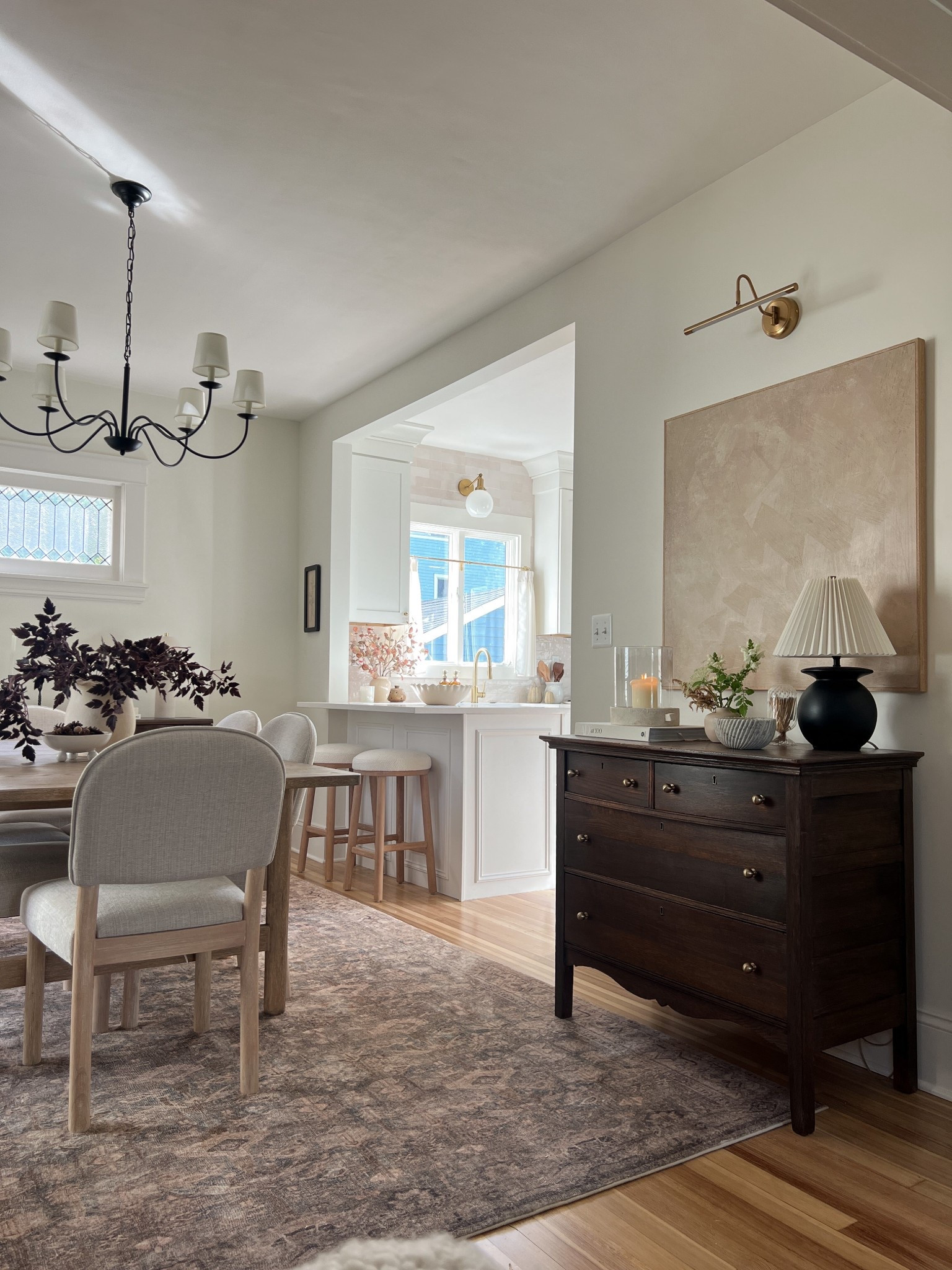 Dining room links! 🔗 Picture light, rug, chandelier, dining table, dining chairs, barstools, bowl, art, candle holders, stems, cafe curtains, rings 

#LTKHome #LTKSeasonal
