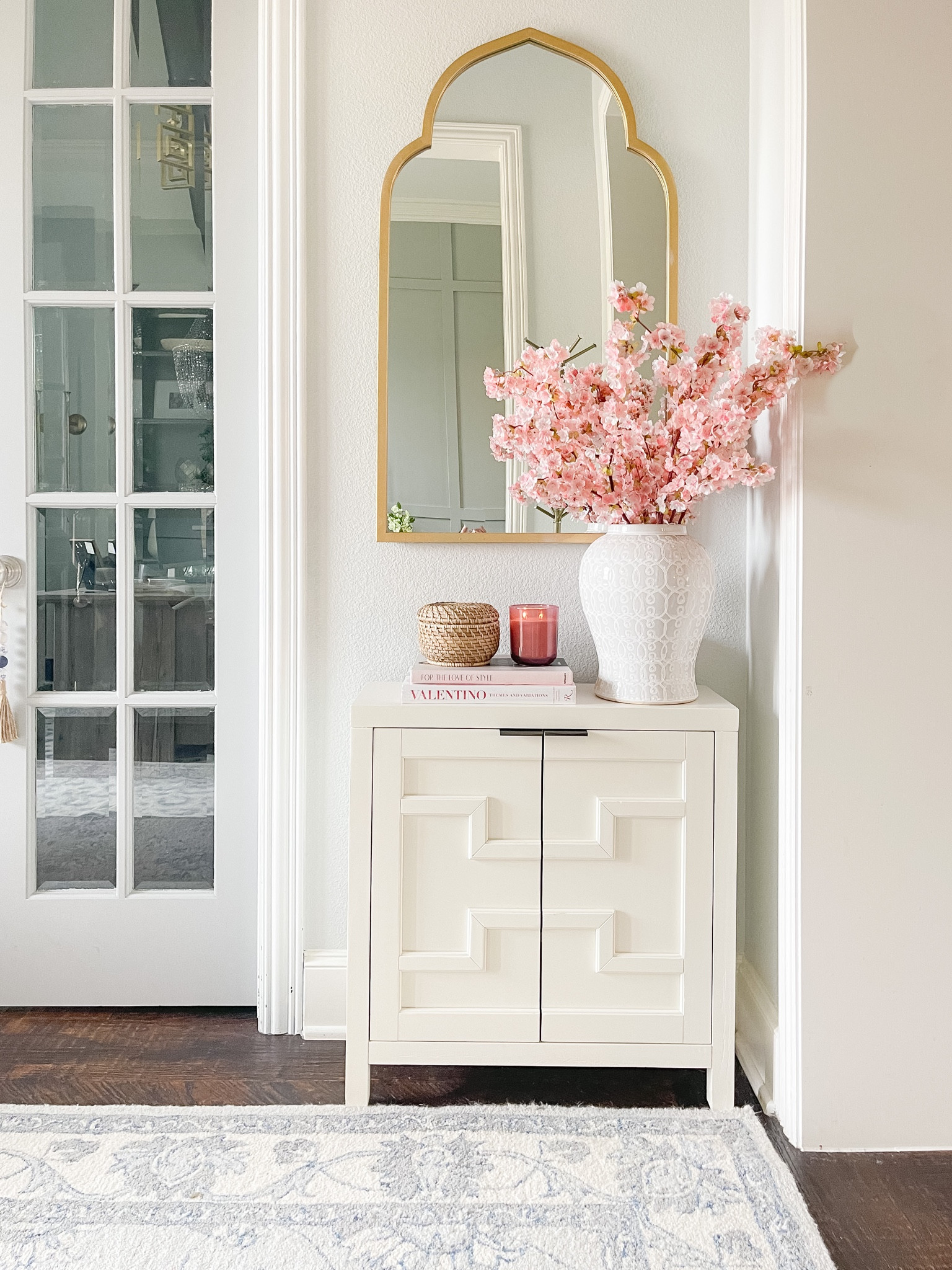 Valentine Decor. Spring decor. Entryway decor. Narrow console cabinet. Pink Cherry blossoms. Pink candle. Pink style books. Woven basket. Entryway. Foyer. 

#LTKSeasonal #LTKstyletip #LTKhome