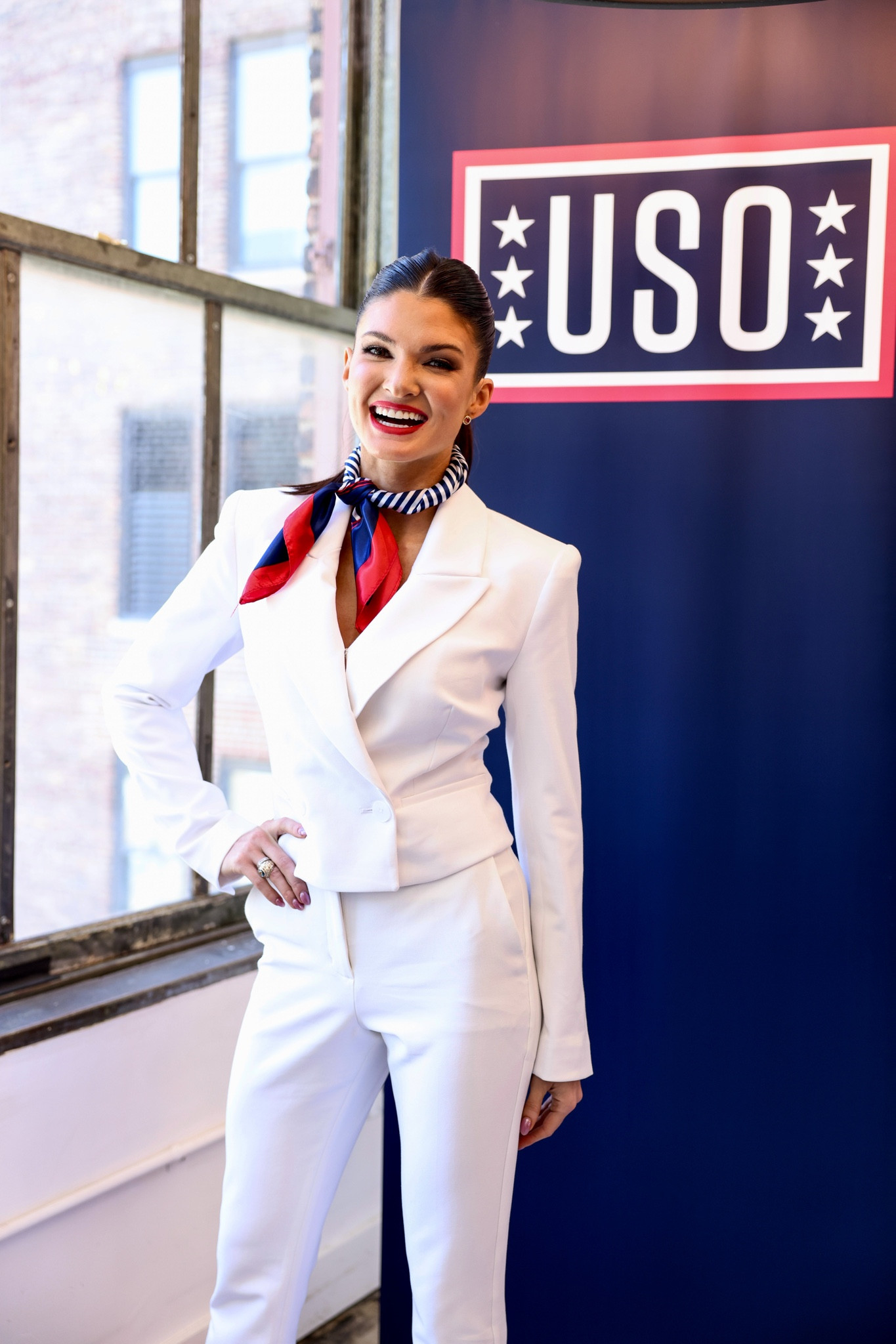 White matching suit set with red, white, & blue scarf. Bold red lip & slick back pony tail. 

#LTKstyletip #LTKbeauty #LTKworkwear