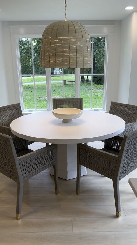 Modern coastal dining room furniture! White table, rattan dining chairs, woven chandelier and a marble bowl. 

#LTKhome #LTKSeasonal #LTKfamily