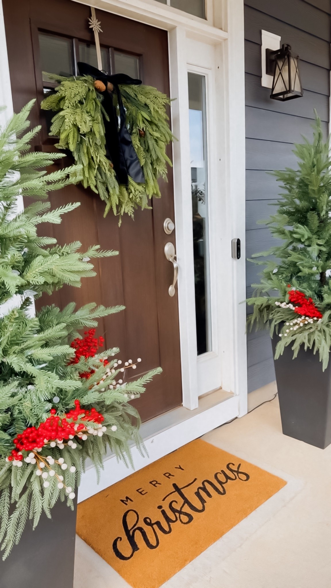 Our Christmas porch filled with soft greenery, potted trees, and an elegant wreath moment. Shop my holiday front-porch decor on LTK.

#christmasdecor #holidaydecor  
#minimalistchristmas #frontporchdecor #porchdecor #winterdecor  
#christmastree #christmaswreath #homedecor #cozychristmas #neutralchristmas  
#wreath #greenerydecor  
#christmastime

#LTKCyberWeek #LTKHome #LTKHoliday