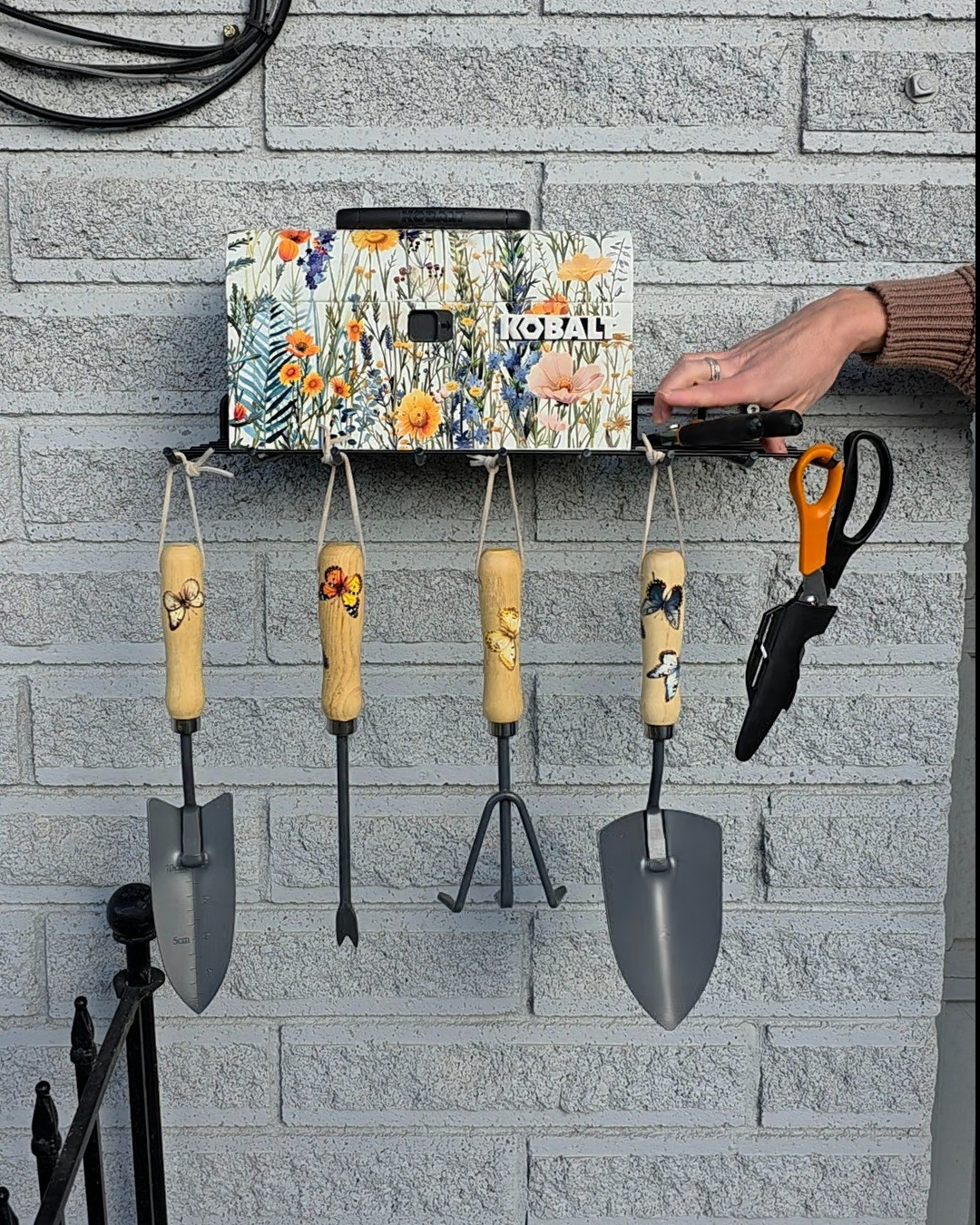 Simple shelf, but it makes a world of difference in our garden area. The mini toolbox holds the garden gloves (to keep spiders out) and the hooks are perfect for hanging hand tools. #garden #storage  

 #LTKHome