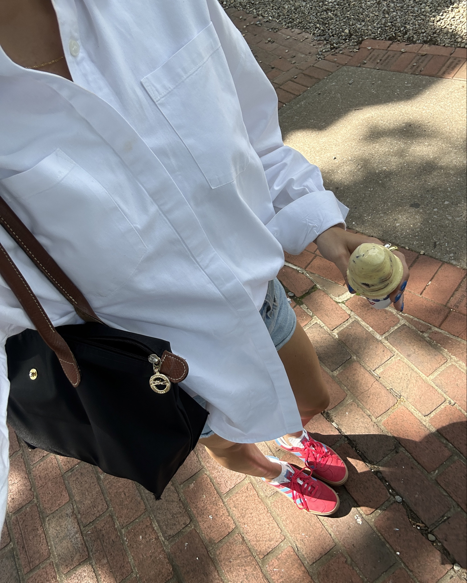 White button down over shirt shirt with denim shorts and red adidas sneakers 

#LTKstyletip #LTKfindsunder50 #LTKSeasonal