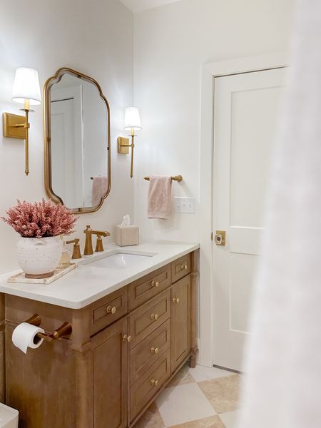 Light and bright guest bathroom details! My best rules when getting my gold hardware to match is to avoid anything too shiny and keeping everything a warm hue. Loving the glam look of this space 

Guest bathroom, bathroom decor, gold detail, warm whites, neutral wood tones, pops of pink, spring refresh, style inspo, wall sconce, checkered floor tile, bathroom refresh, neutral aesthetic, Wayfair, Home Depot, Target, found it on Amazon, bathroom detail, shop the look!