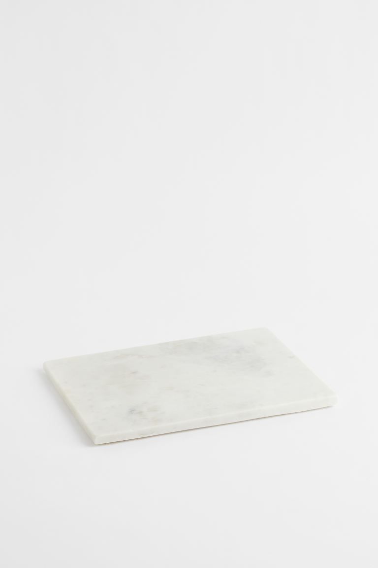 Serving board in marble with silicone feet underneath. Size approx. 1/2 x 9 3/4 x 13 3/4 in. Marb... | H&M (US)