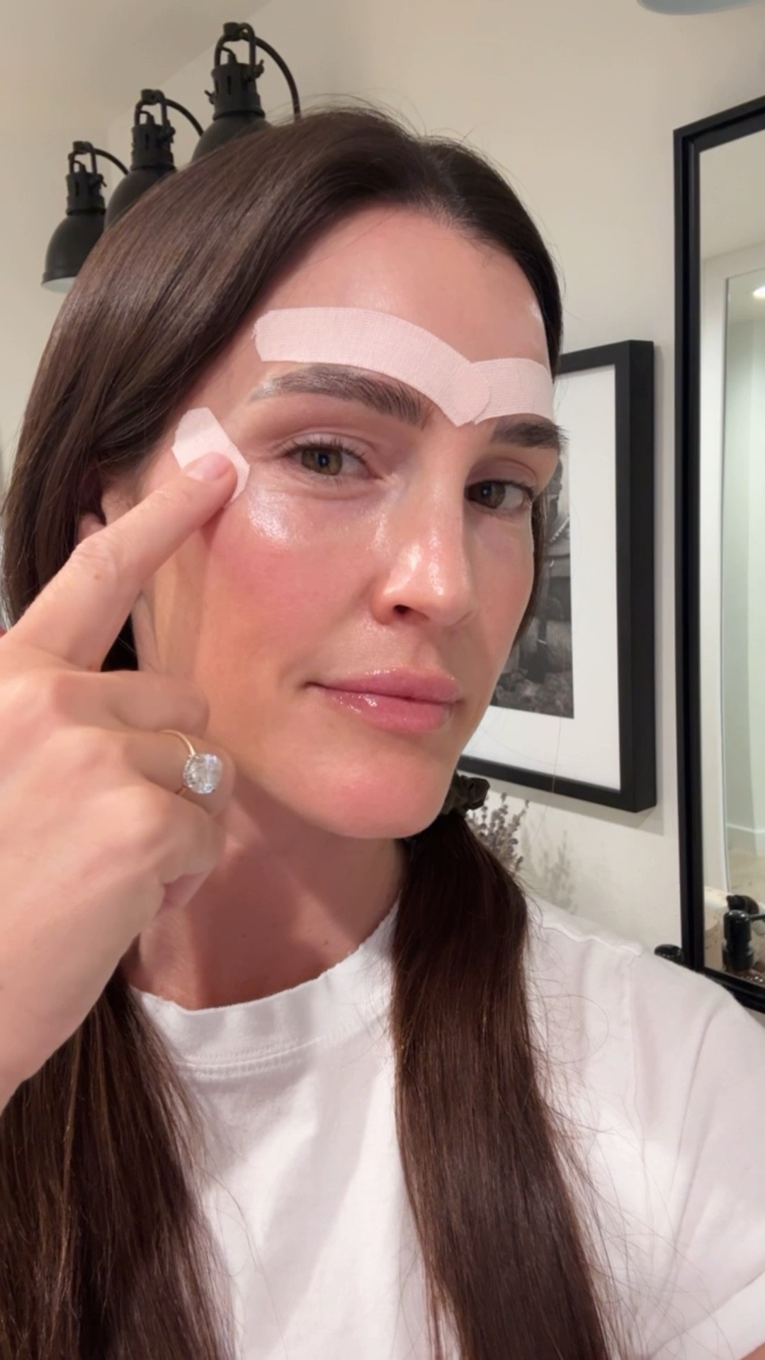 I’ve been face taping for two years to help smooth out my skin 🩹 These two applications are still my favorites—I do this three to four times a week. First I apply my skincare and wait about fifteen to twenty minutes for it to really sink in, then I place two pieces right above my brows to lift and smooth those elevens, and another on the sides to gently lift the skin around my eyes and soften my crow’s feet. It’s such a simple, noninvasive way to wake up looking a little more refreshed.