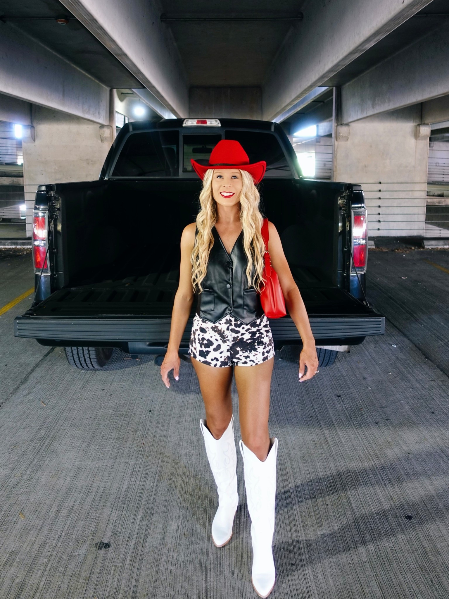 COUNTRY CONCERT OUTFIT! This western styled country concert outfit + cowgirl boots are perfect for your next concert, music festival, rodeo, Nashville trip, or bachelorette party!

The cow print shorts with the leather vest, white cowgirl boots, + red cowgirl hat make a trendy concert outfit. 

I’m wearing an XS in the highrise cow print shorts  

#LTKStyleTip #LTKSeasonal #LTKParties