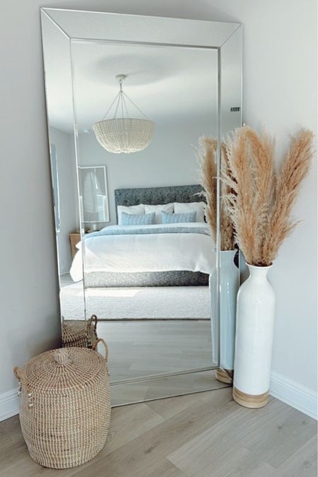 Modern Coastal Bedroom Inspo 🌊✨ Add this home decor + bedroom furniture to make your home feel bright, airy, + cozy with a touch of modern coastal vibes 🐚

For bedding, start with a classic white foundation by using the best-selling white honeycomb duvet cover + matching pillow shams. These have a subtle texture so it's not "blah."

Use the chambray cloud quilt to add a pop of color that gives the room the calming coastal color palette. 

Another way to add interest to the space is with decor! The white-washed wood bead chandelier adds character and charm while also brightening up the room.

The nightstands are shown in a seafrift finish which gives the bedroom a beachy, coastal look. This collection has a variety of size options and matching furniture (like dressers, storage...)

The palm leaf wall art helps to balance the room and adds to the coastal feel.

The oversized mirror makes the room appear larger. It’s styled with a large vase filled with dried pampas + a seagrass woven basket. This lidded basket comes is decorative + gives additional storage. 

Modern Coastal Bedroom, Master Bedroom, Home Decor, Modern Coastal Home, Neutral Home Decor, neutral bedroom, boho bedroom, Pottery Barn, Bedroom Inspiration, Florida Home, Beach House, Neutral bedding, guest bedroom, beach home, bedroom styling, bedroom wall art, bedroom chandelier, beaded chandelier, master bedroom styling, master bedroom decor, beach home decor, Sausalito nightstand, natural wood nightstand, bedroom set, bedroom furniture, master bedroom bedding, neutral comforter, coastal bedding, white bedding, blue bedding, nightstand styling, cozy bedroom, bedroom lighting, coastal art, coastal wall art, coastal decor, neutral home decorative objects, oversized mirror, wall mirror, baskets, blanket basket, storage basket, bedroom storage, floor vase, oversized vase, chunky knit handwoven rug, ivory rug, hurricane candleholders, Sausalito nightstands 

#LTKSaleAlert #LTKStyleTip #LTKHome