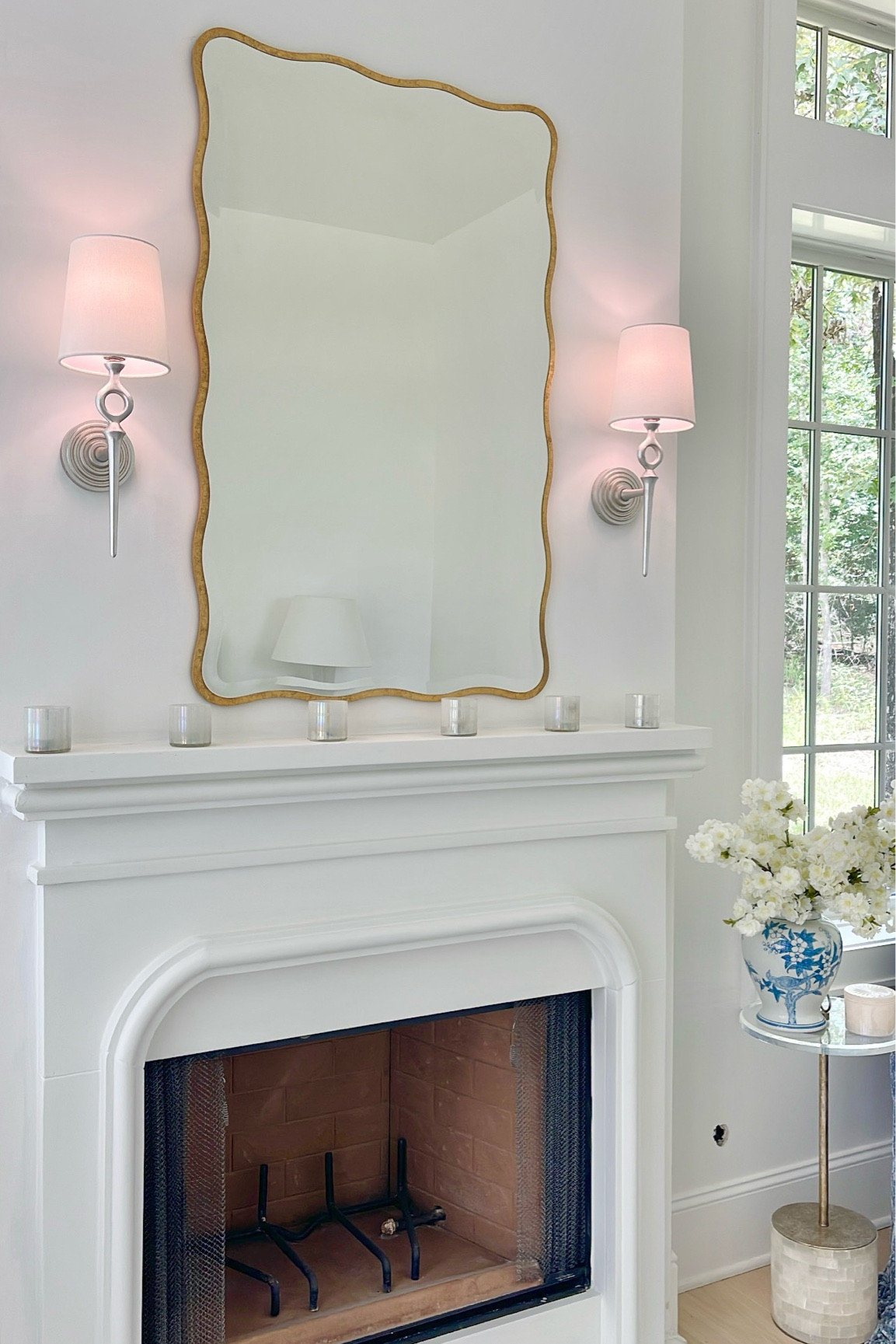 Wall mirror, wall sconces, ginger jar, faux flower stems 