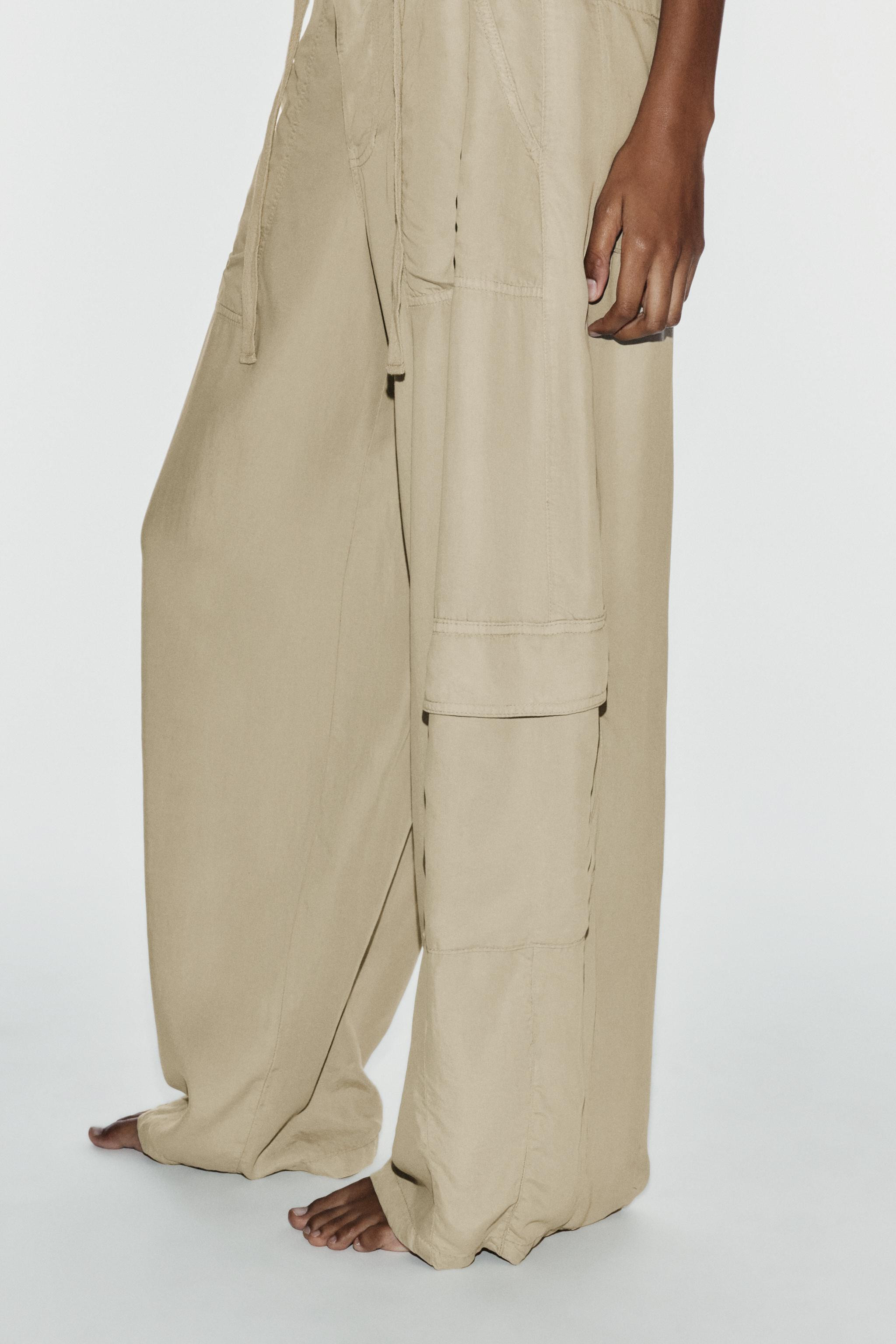 Trousers made from a lyocell blend. Mid-waist design featuring belt loops and adjustable ties. Pa... | Zara UK