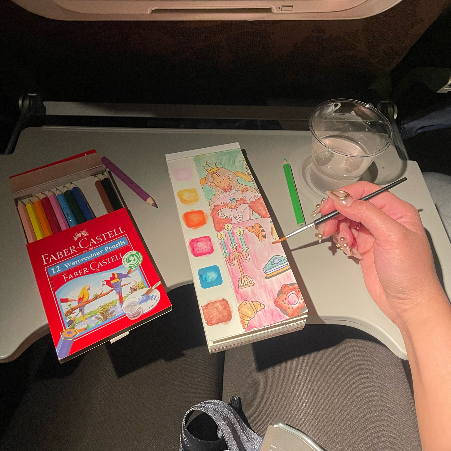 my fave pocket coloring book on a long flight ✈️ love how it’s got a brush slot at the back so you don’t lose it! such a therapeutic relaxing hobby 