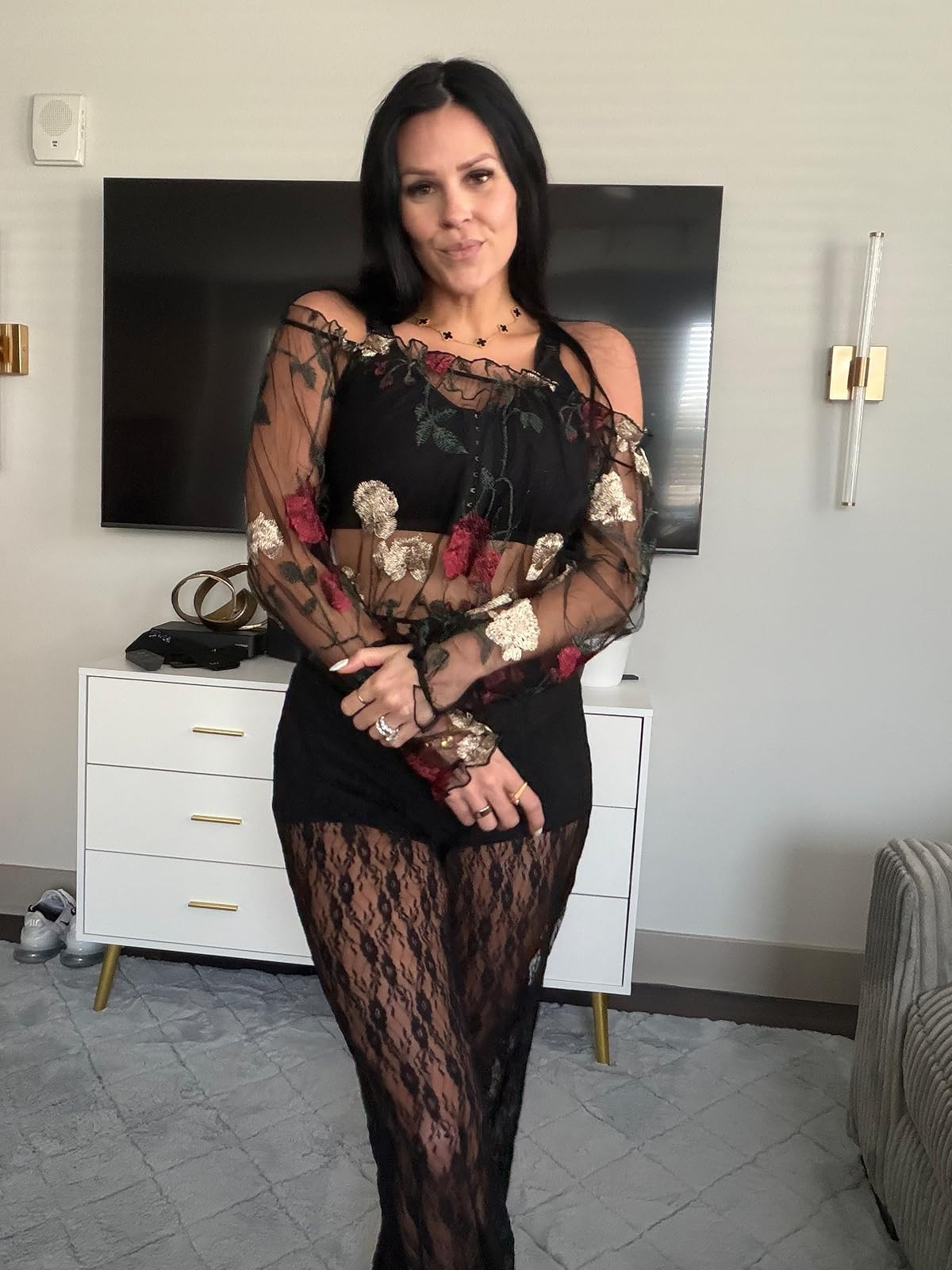 Gothic romance. This sheer black off-the-shoulder top with red and gold floral embroidery paired with delicate lace trousers is a stunning, moody statement look. #FloralMesh #LaceTrousers #LTKstyletip 

 #LTKSpringSale #LTKgrwm #LTKootd