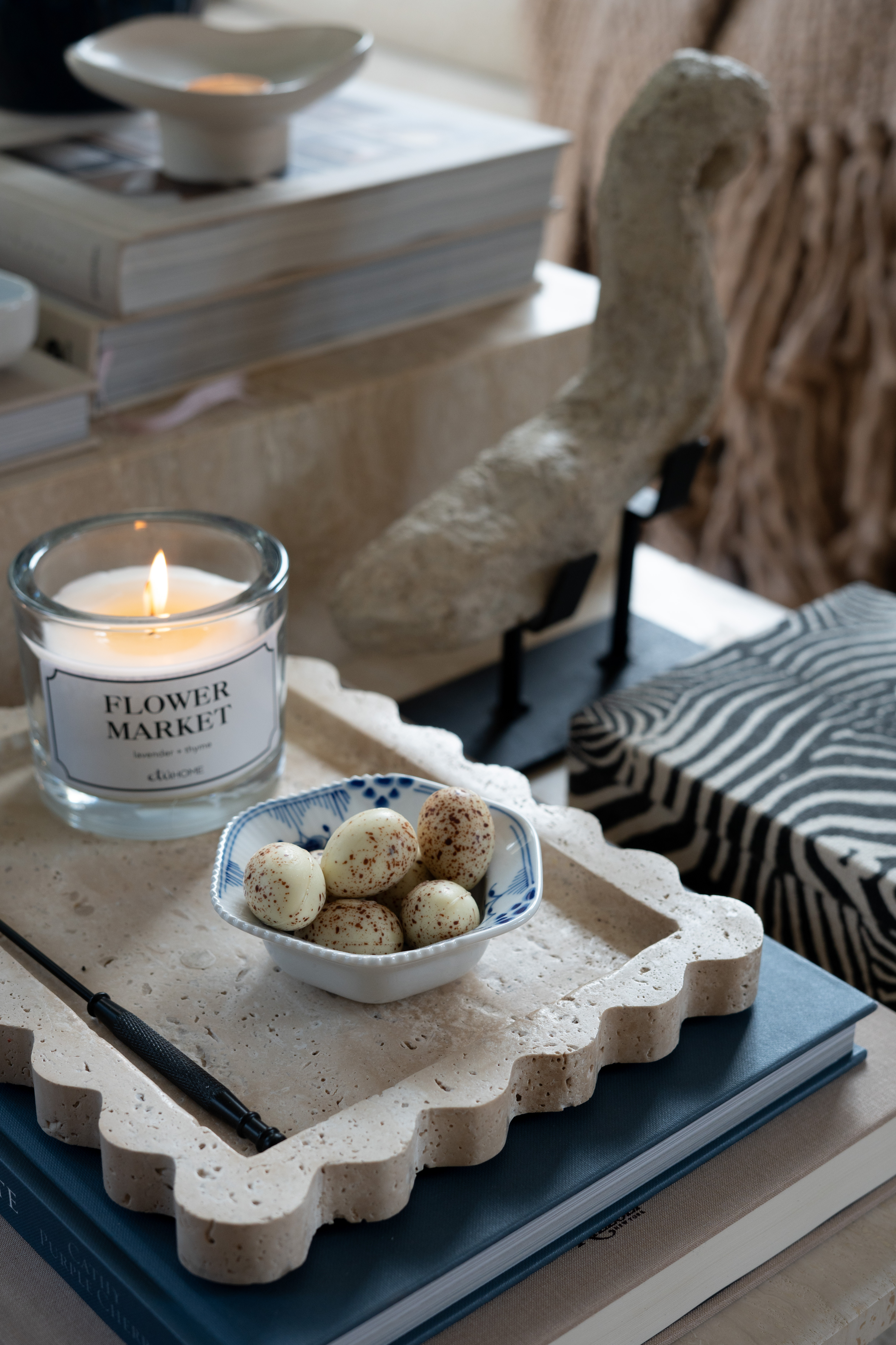 OMG you guys I cannot get over this little coffee table moment. The marble tray, lit candle, stacked design books, and the cutest bowl of treats are giving the most perfect cozy living room vibes. These layered textures and neutral tones make the whole space feel calm, warm, and beautifully styled.  

 #LTKdayinmylife #LTKSeasonal #LTKHome