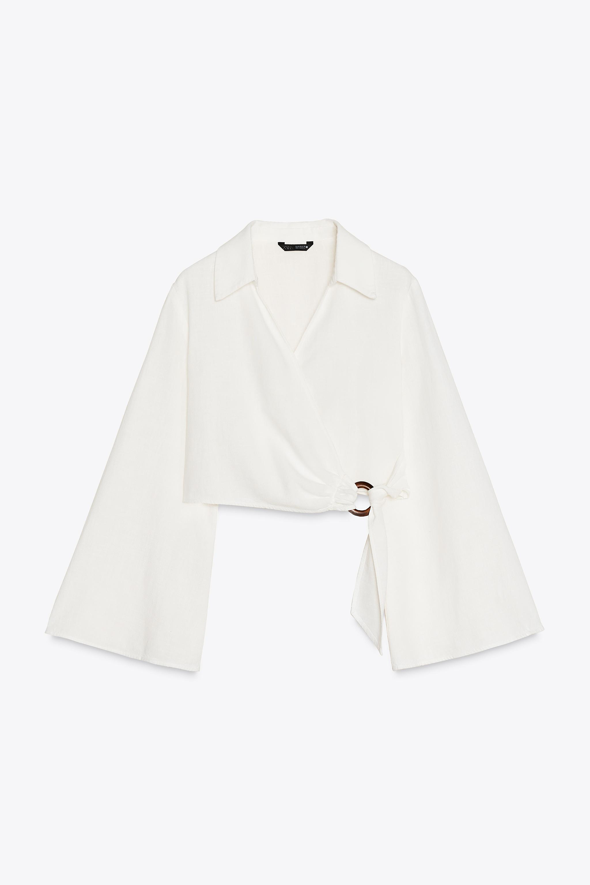 Short top with lapel collar, V-neck, and long flared sleeves. Front wrap closure with hidden butt... | Zara US