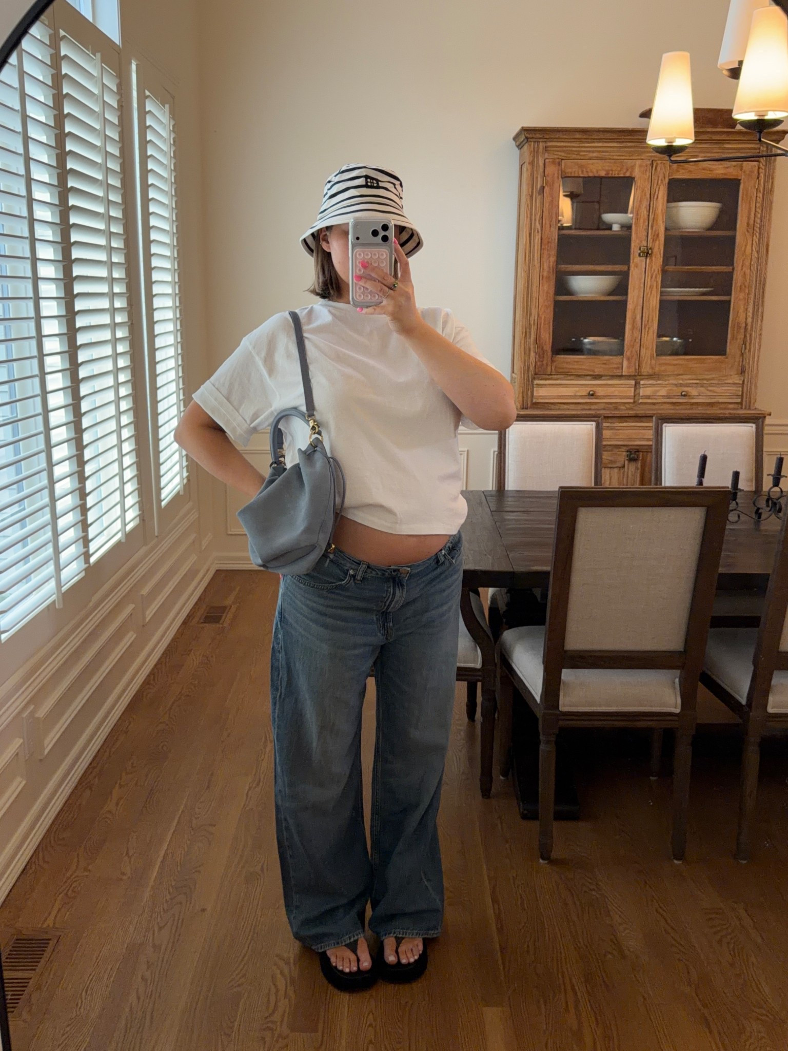 Size XS in tee it runs really loose and oversized so I went down a bunch! Anine Bing bucket hat love the stripes. Flip flops true to size and really comfy. Adorable blue suede bag from Madewell! Madewell jeans are so good they have a stretchy rigid denim fit so flattering. I’m 20+ weeks and size 31 up two from my usual size but they have lots of room. Size down I think one size for a more accurate fit! 

#springstyle #lowrisejeans #madewell #aninebing #pregnancystyle #pregnant 

#LTKBump