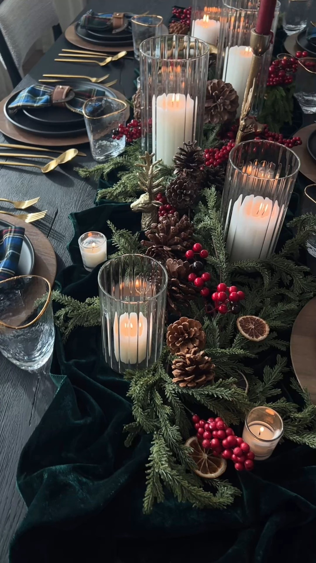A Ralph Lauren tablescape centerpiece for your  Christmas table! You could set this up all season long until you set the table! Hunter Green velvet runner, pinecone stems, Christmas berries, ribbed cylinder candle holders, antlers, stag decor, dried oranges, lodge aesthetic

#LTKHome #LTKHoliday #LTKSeasonal