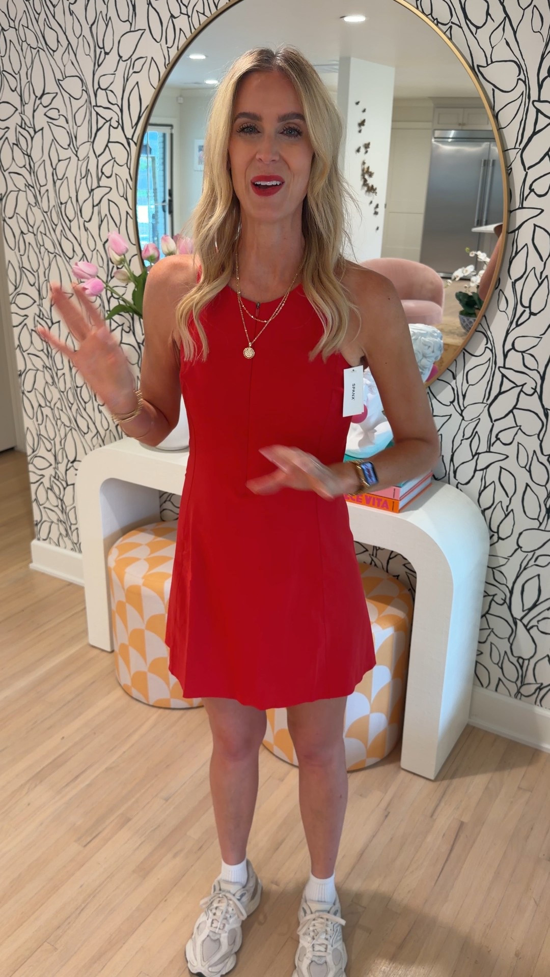 Spanx red active dress! Built-in shorts that come down for easy bathroom access. No built-in bra. I would say it is true to size. I wish I had sized up to a medium just for height purposes.
