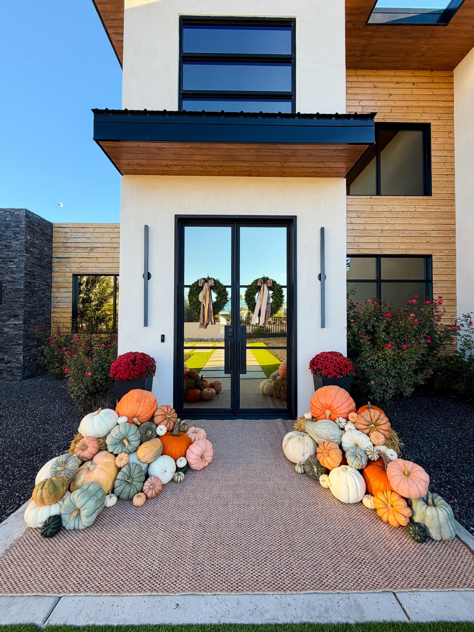 Fall front porch is officially done 🎃 Heirloom pumpkins piled high, burgundy mums, and matching wreaths on the double doors make the warmest welcome home 🍂

#LTKhome #LTKseasonal #LTKover40 

 #LTKSeasonal #LTKOver40 #LTKHome
