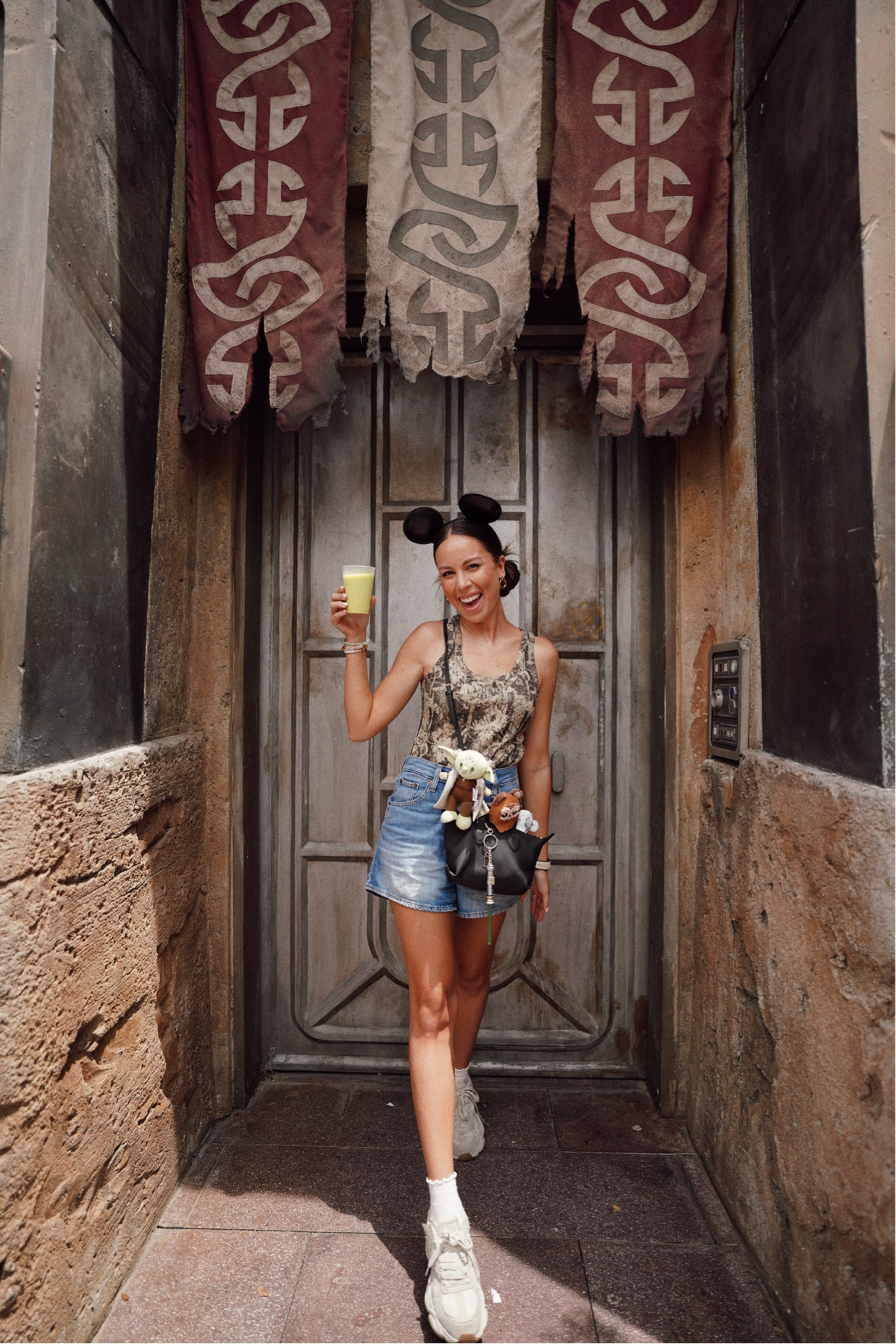 Tank top is from her universe!! Star Wars Day May the Fourth Outfit🖤 comfy Disney outfit, Disney ootd, Disney outfit ideas, Disney outfit inspo, Disney girl, Disney merch, Disney accessories, Disney style, Disney parks, camo tank top, Levi’s mid thigh mom denim shorts, Jean shorts, Mickey Mouse ears, Stoney clover bag 