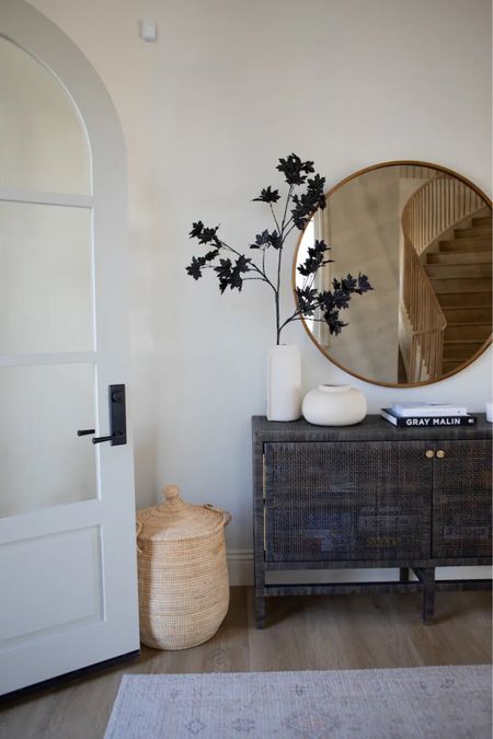 Designed by Becki Owens. Rich fall entry decor. Foyer console decoration ideas. Best neutral decor. How to decorate your entrance console. Ceramic vases. Large Round mirror. White candle. Wooden bowl tray. Coffee table books. Rattan wicker basket hamper with lid. 

#LTKhome #LTKsalealert #LTKstyletip