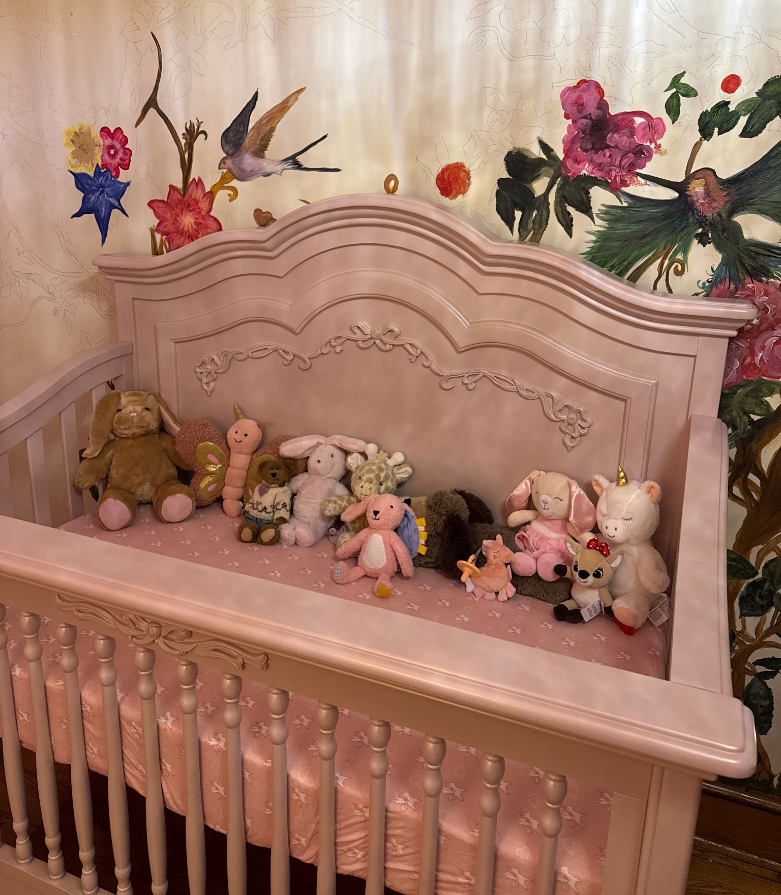 Designing my daughter’s crib space was one of the sweetest parts of preparing for her arrival. It’s beautiful hand-crafted piece in the softest mauve pink, finished with the sweetest bow details that add such a delicate, timeless touch to the room. I wanted her space to feel cozy, calm, and full of love from the very beginning.

Before she was even born, all of her little stuffies were already patiently waiting here for her arrival. Seeing them lined up in her crib made everything feel so real and so special. Now they’ve become part of our daily routines, from playtime to winding down at night.

This little space holds so many sweet moments already, and I know it will continue to as she grows.

I will be transparent and say it took 8 weeks for the crib to ship. I am not kidding when I say each one is hand crafted. Meaning they aren’t sitting and ready to ship at a warehouse. Anyway, below are the exact items linked if you’re interested in anything from her crib setup. 🌸💗🎀🦄

#LTKBump #LTKmomlife