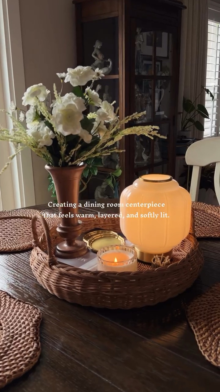 Creating a dining room centerpiece that feels warm, layered, and softly lit.

Step 1: Start with a woven tray for structure
Step 2: Let the lamp become the glow of the table
Step 3: Add one taller piece for balance
Step 4: Mix warm wood, glass, and brass tones
Step 5: Finish with candlelight and cozy details

Save this for your next slow evening at home.

#cozyhome #cozyathome #cozy #howto #vintagemodern