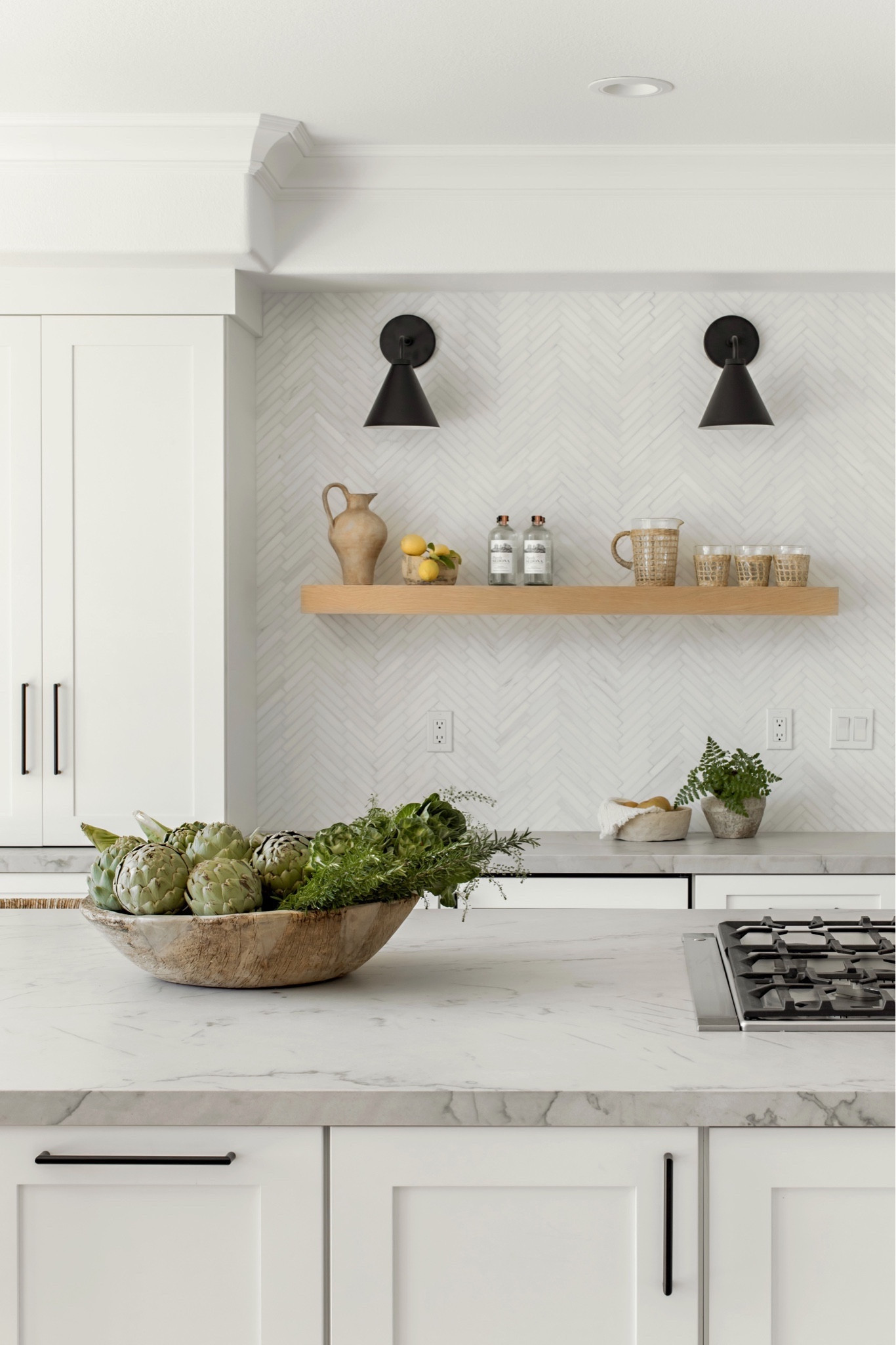 Our California casual kitchen remodel features quartzite countertops, white shaker cabinetry, a featured white herringbone backsplash, and black sconces. 

#LTKfamily #LTKhome #LTKstyletip