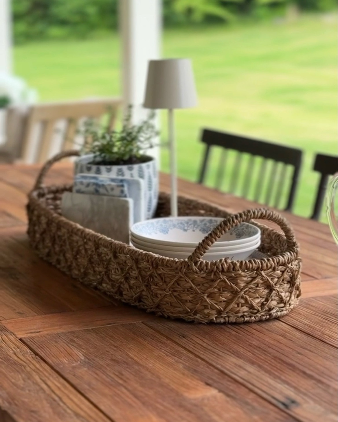 Styling our outdoor dining table for summer. I added this oval woven tray, a waterproof lamp with a nice heavy base so it stays put on breezy days, and a few flowers for a simple layered look.

I love using a woven tray on a table because it helps gather several items together and makes everything feel more grounded and intentional.

#LTKHome