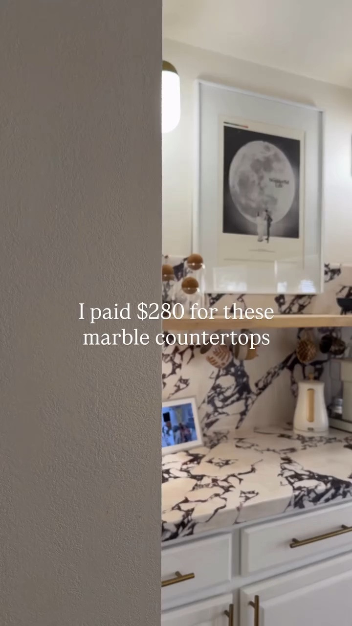 Follow, Save and Comment SHOP for a link. 

This was such a budget-friendly way to get the look I wanted without the commitment. 🤍
That’s honestly my favorite part — if I change my mind someday, I can just remove it… or even swap it out for a totally different contact paper down the road.

I get asked all the time how this has held up, so here’s the real-life update:
I’ve had it on my coffee bar for about a year and a half, and in the rest of the kitchen for around six months — and it’s held up extremely well.

There are a few scratches and tiny dings where something’s hit it (which is to be expected), but overall I’ve been really impressed. I didn’t even caulk around the sink, and the adhesive is so strong that nothing is peeling — even with water constantly splashing everywhere thanks to my toddler.

If you’re in a rental, on a budget, or just not ready to commit to real stone, this is such a solid DIY option.

No regrets. I’d absolutely do it again.

#budgetkitchen #diykitchen #contactpaper #kitchenmakeover #renterfriendly