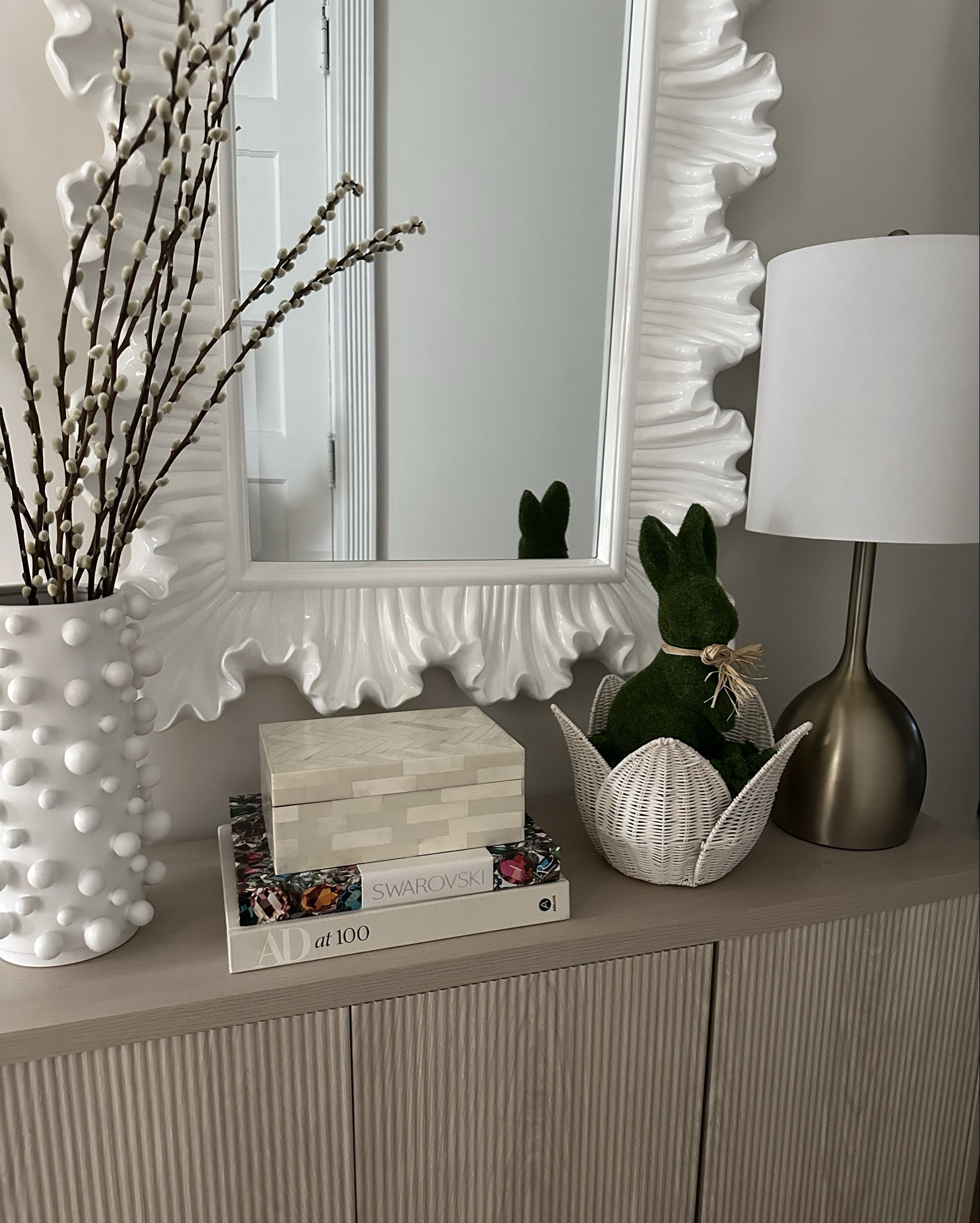 Spring Easter console decor refresh 🤍🌿 Sharing this neutral Easter entryway styling featuring a moss bunny, white textured vase, decorative coffee table books, and modern sculptural mirror — the perfect way to decorate your home for Easter without going overly themed.

This spring console table decor is ideal for Easter hosting, entryway styling, and creating a soft, organic spring home refresh. I love mixing natural textures like wicker, moss, and ceramic with clean white decor for an elevated Easter look that feels timeless and chic. #easterdecor • #springdecor • #easterhome • #springhome • #easterentryway • #consoletablestyling • #springconsole • #neutraldecor • #modernhomeinspo • #ltkhome • #ltkspring • #ltkseasonal • #easterstyling • #springrefresh • #hostessinspo

#LTKHome #LTKmomlife #LTKSeasonal