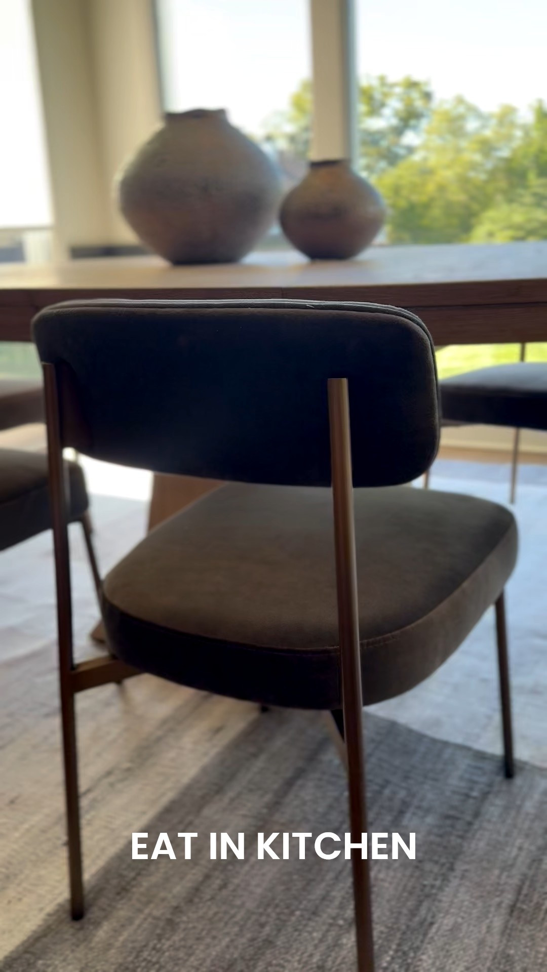 Eat in Kitchen with timeless staples, velvet chairs, wood oval table, and gorgeous large vases 