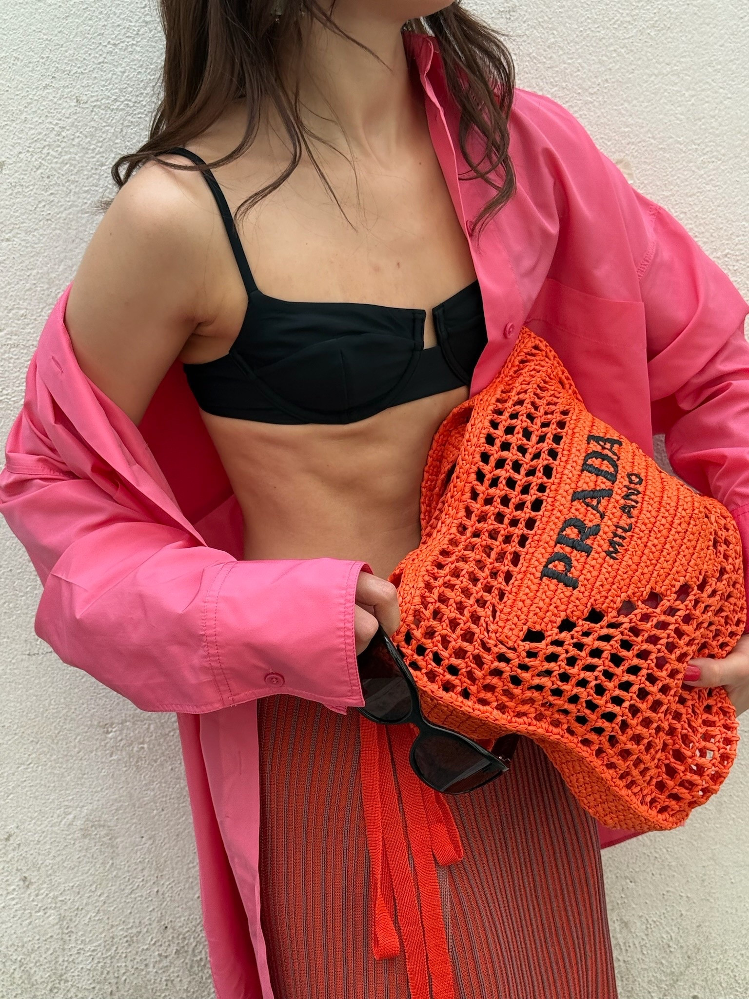 European summer street style goals! 🌸🍊 Loving this bold color-blocked look pairing an oversized hot pink button-down layered over a black bandeau with a low-rise terracotta wrap skirt. Finished off with the iconic Prada raffia tote in bright orange and sleek black slingback heels. Everything is linked below! ✨

#LTKgrwm #LTKootd #LTKU