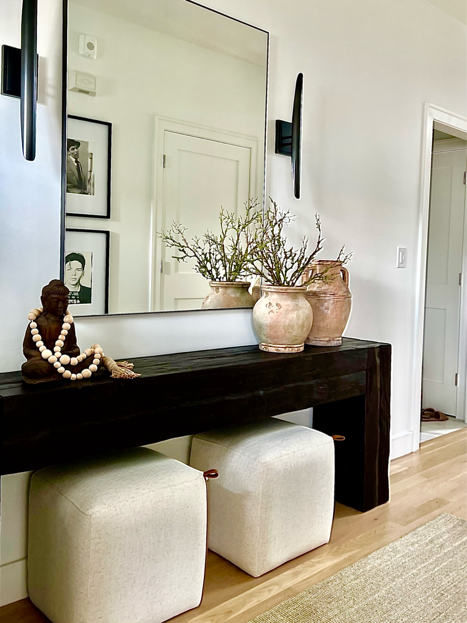 First impressions matter! This is one of my favorite entryways my team has assembled. Shop this space to create a visual that your guests will never forget!
Wall sconce, rectangular black wall mirror, linen rug runner, square ottoman, console, planter.

#LTKhome #LTKFind #LTKstyletip