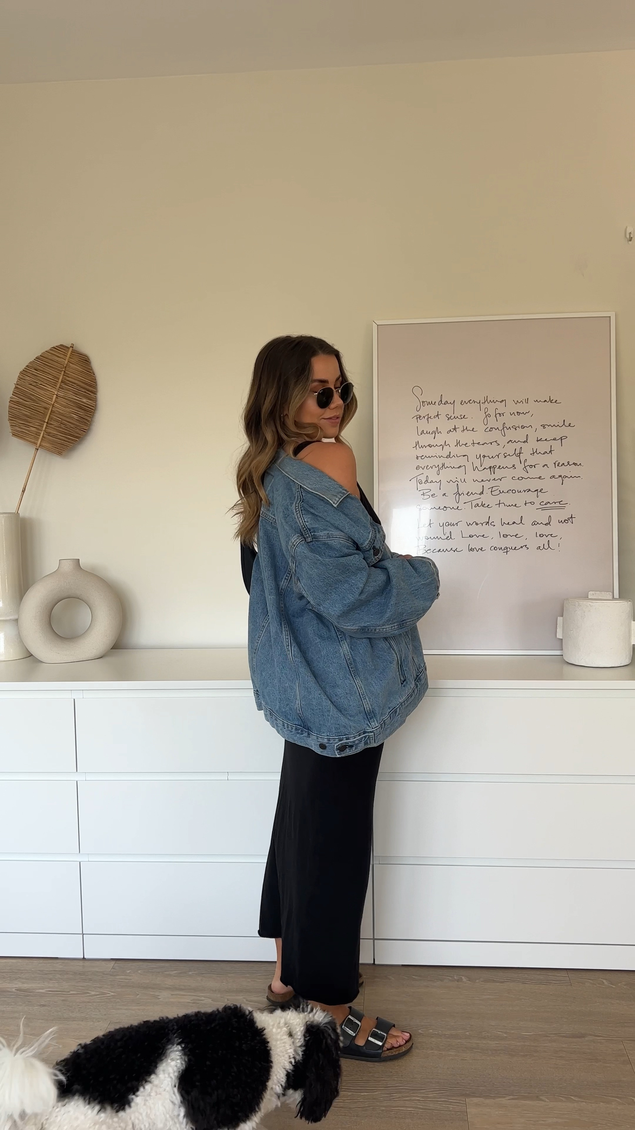 Oversized denim jacket styled over black maxi dress with black birkenstock Arizona sandals - classic, simple outfit 