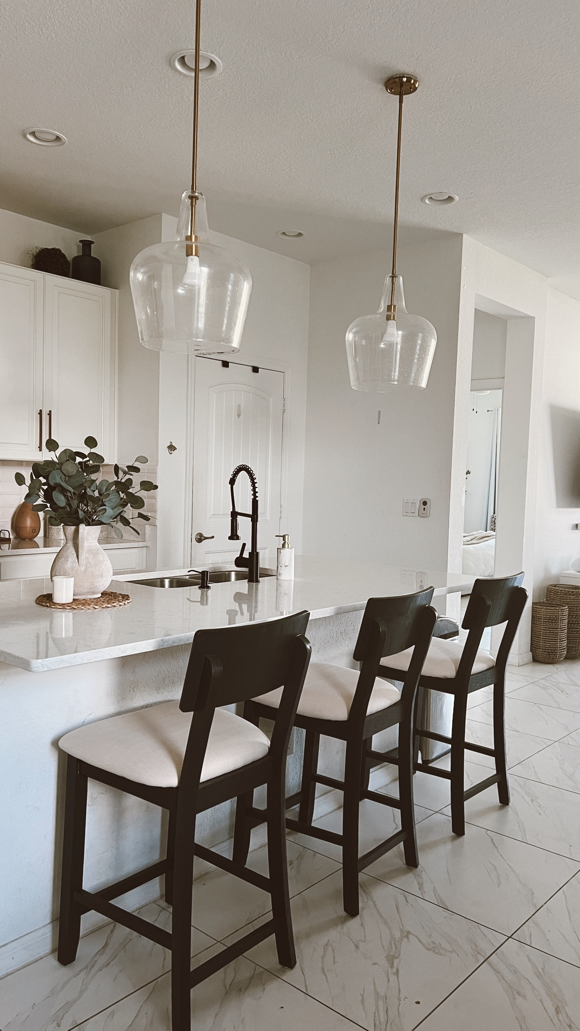Sprucing up your builder grade kitchen is a must. 

Glass Gold Pendant Lights: arent linkable on LTK (https://www.signaturehardware.com/harney-pendant-light---single-light/953461.html) 
- Tip: go LARGE with your pendant lights (at least 14” wide)

Rustic vase: exact one not linkable so I linked VERY similar ones! 