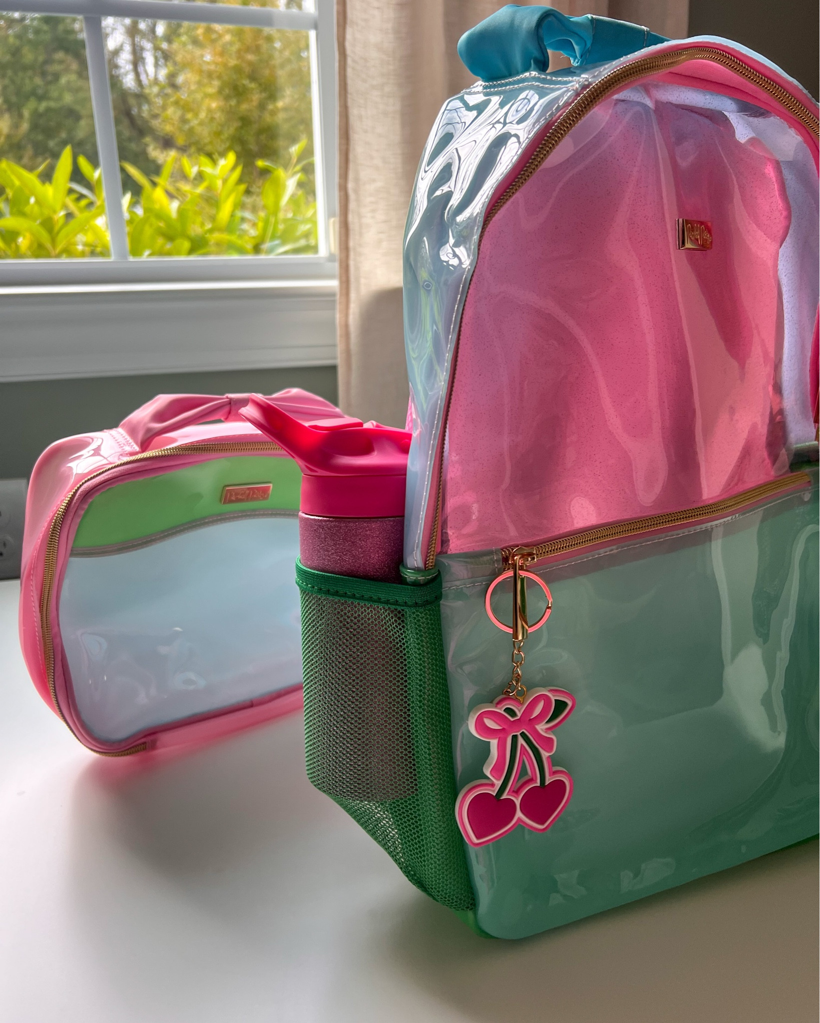 How cuteeee are these backpacks!? 🎒 

We have the Back to Fun Color Block backpack, lunchbox, and pencil case. My daughter literally squealed when she spotted the bows and the cherry keychain detail! 🍒✨ 

Added bonus: the backpack is clear, so on the first day I knew she had her teacher gift, school supplies, and snack without even unzipping it. Plus, the bags are water-resistant for easy wipe-downs and antimicrobial-lined for fewer germs!

I also linked the BPA-free 12oz iridescent glitter water bottle ✨ It’s double-wall vacuum insulated and comes with a pop-up straw — the perfect sparkly school-day essential!

#ad #packedparty 

#LTKKids #LTKFamily