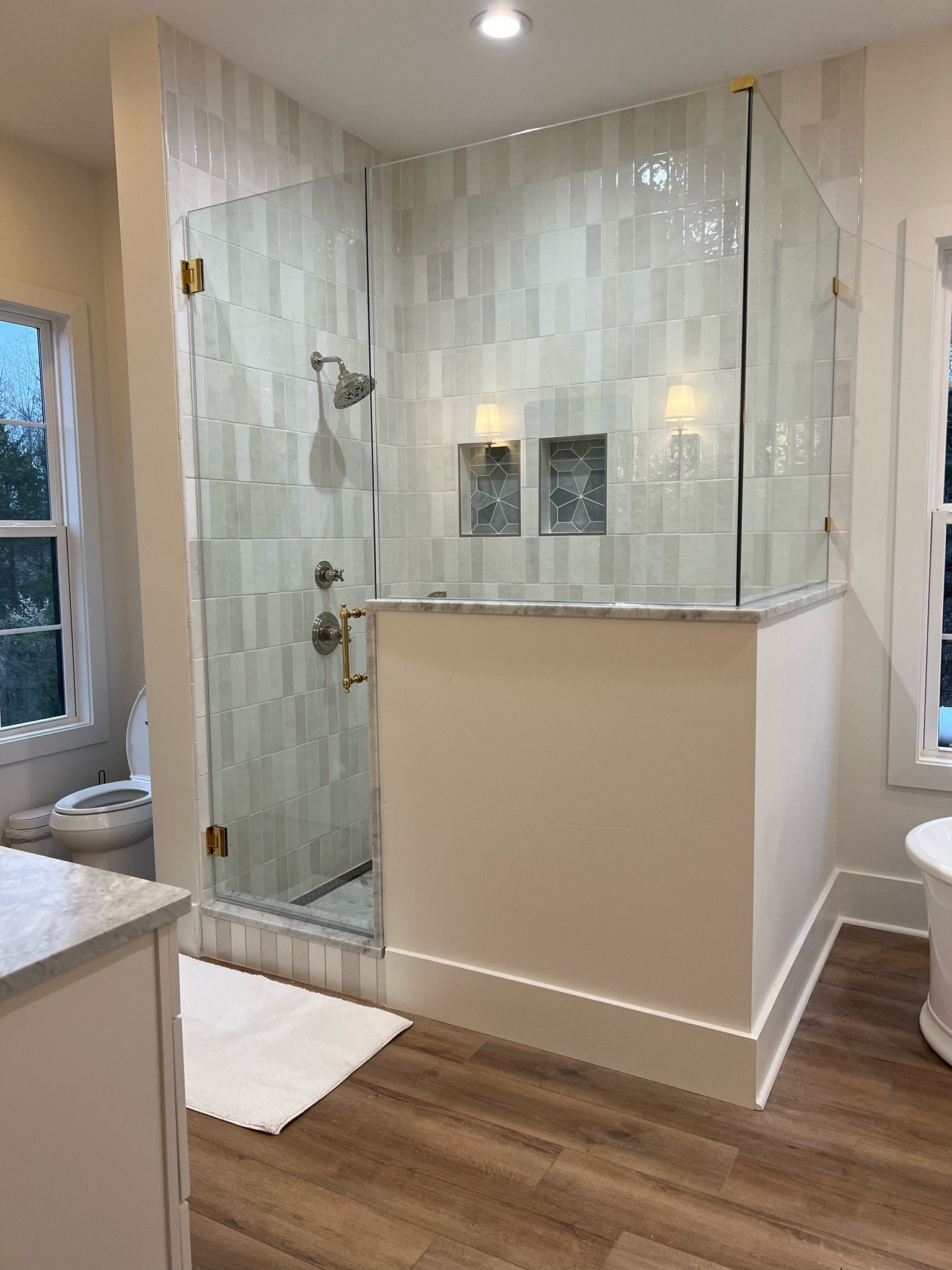 Our primary bathroom shower is a dream. Tiled to the ceiling with Bedrosian cloe tile and two mosaic marble shower niches - she is just so pretty. Plus I mixed polished nickel shower fixtures with brass on the shower glass to tie the bathroom together. 

#LTKhome #LTKstyletip