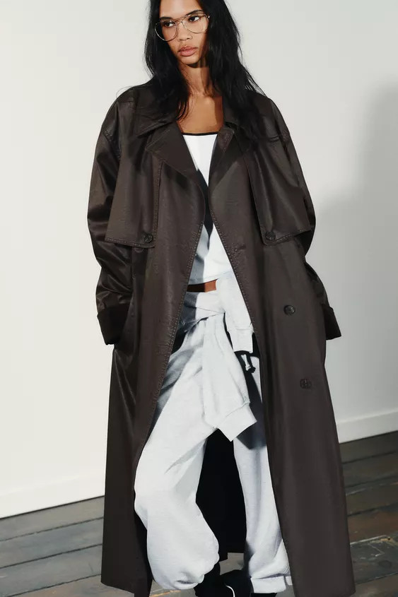 Long trench coat made of wax-effect fabric with a lapel collar and a crossover V-neck. Long sleev... | Zara US