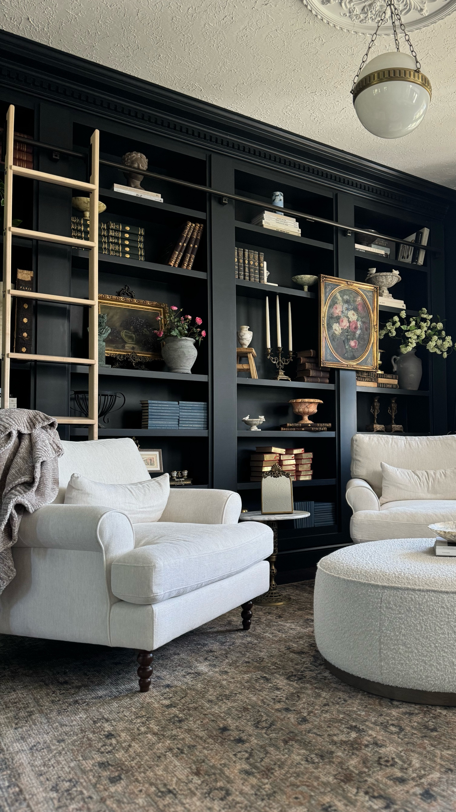 Shop my vintage modern style moody library living room space.  #livingroom #library #moody #builtins #chairs #accentchair #ottoman #lighting 

#LTKHome