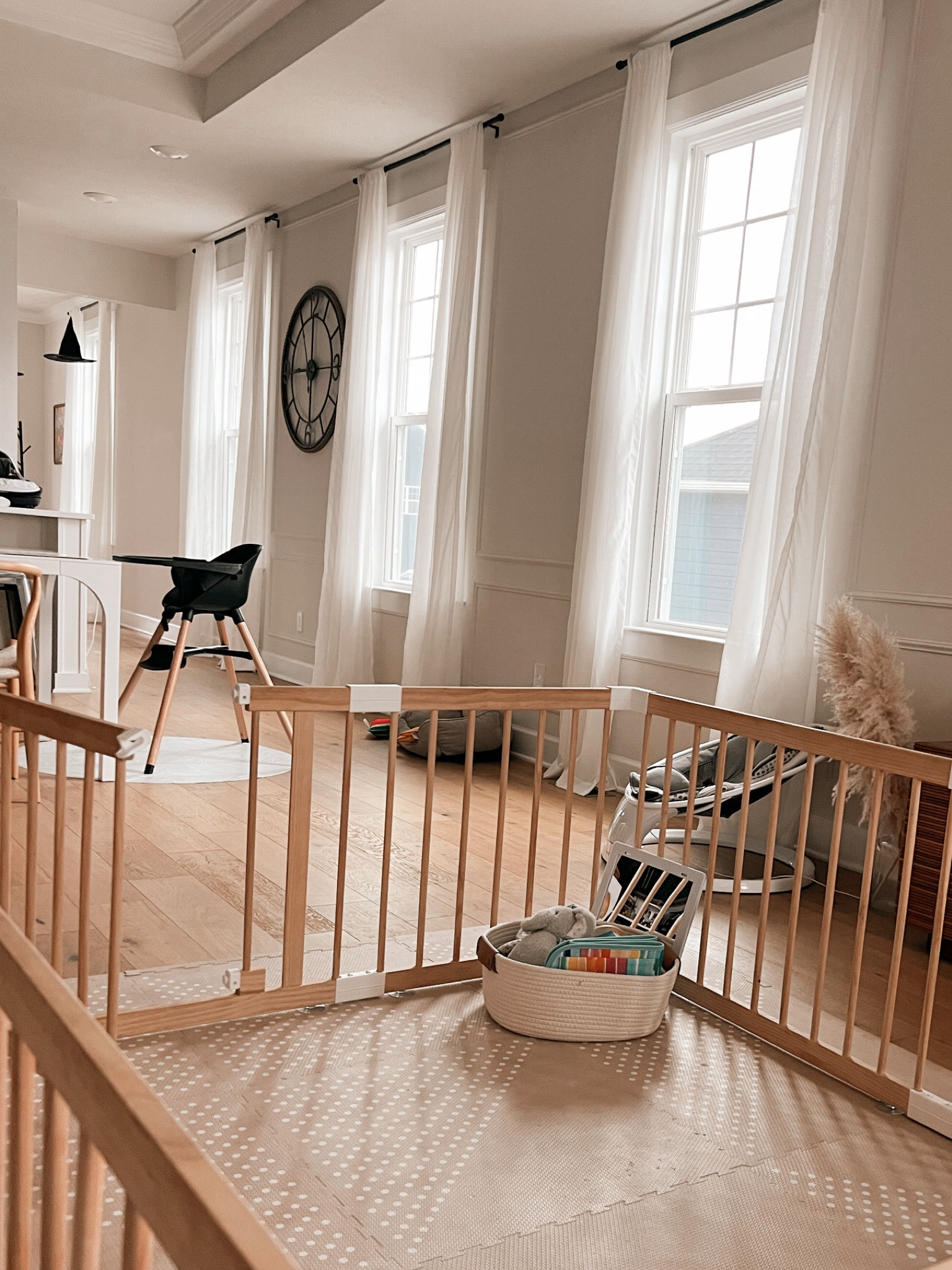 Neutral living room but with a baby and a toddler.  Some daily items you need on your baby registry to keep your space looking adult while having littles 🤍
.
#neutralaesthetic #falldecore #neutralbabyitems #neutralbabygate #babygate #babyswing #blackhighchair #highchair #livingroominspo #playmat #neutralplaymat #whitecurtains 

#LTKKids #LTKBaby #LTKHome